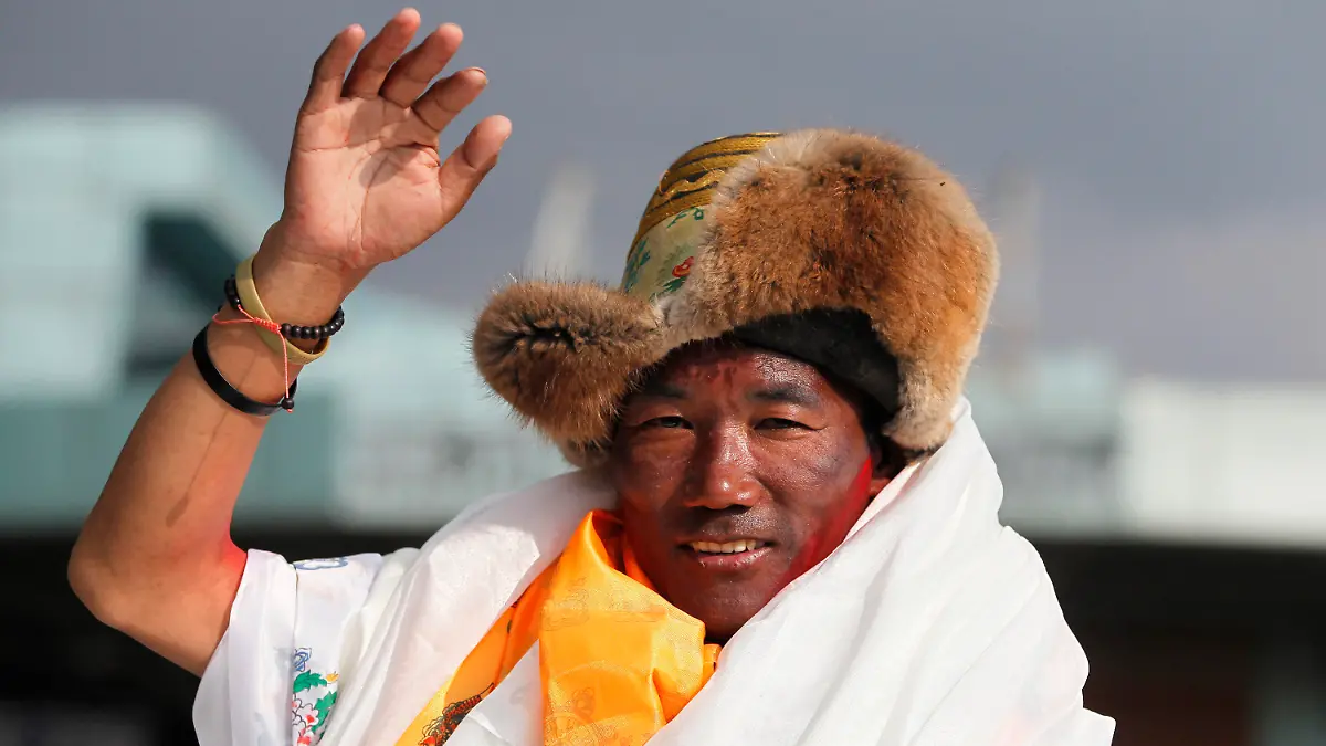FILE - In this May 20, 2018, file photo, Nepalese veteran Sherpa guide, Kami Rita waves as he arrives in Kathmandu, Nepal. Rita, 51, an ace Sherpa guide scaled Mount Everest Friday for the 25th time breaking his own record for the most successful ascents of the world’s highest peak. (AP Photo/Niranjan Shrestha, File)
