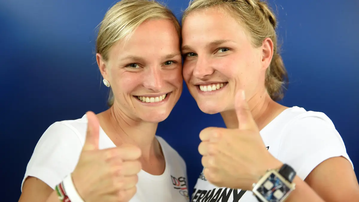 Twins Anna (L) and Lisa Hahner of the German Olympic marathon team pose for media during the kit collection of Germany's Olympic team in Hanover, July 7, 2016. REUTERS/Fabian Bimmer