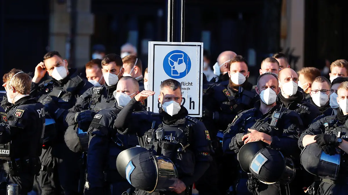 Police officers observe as left-wing activists (Antifa) gather to celebrate the 100th anniversary of Antifa in Frankfurt, Germany, May 7, 2021. REUTERS/Kai Pfaffenbach