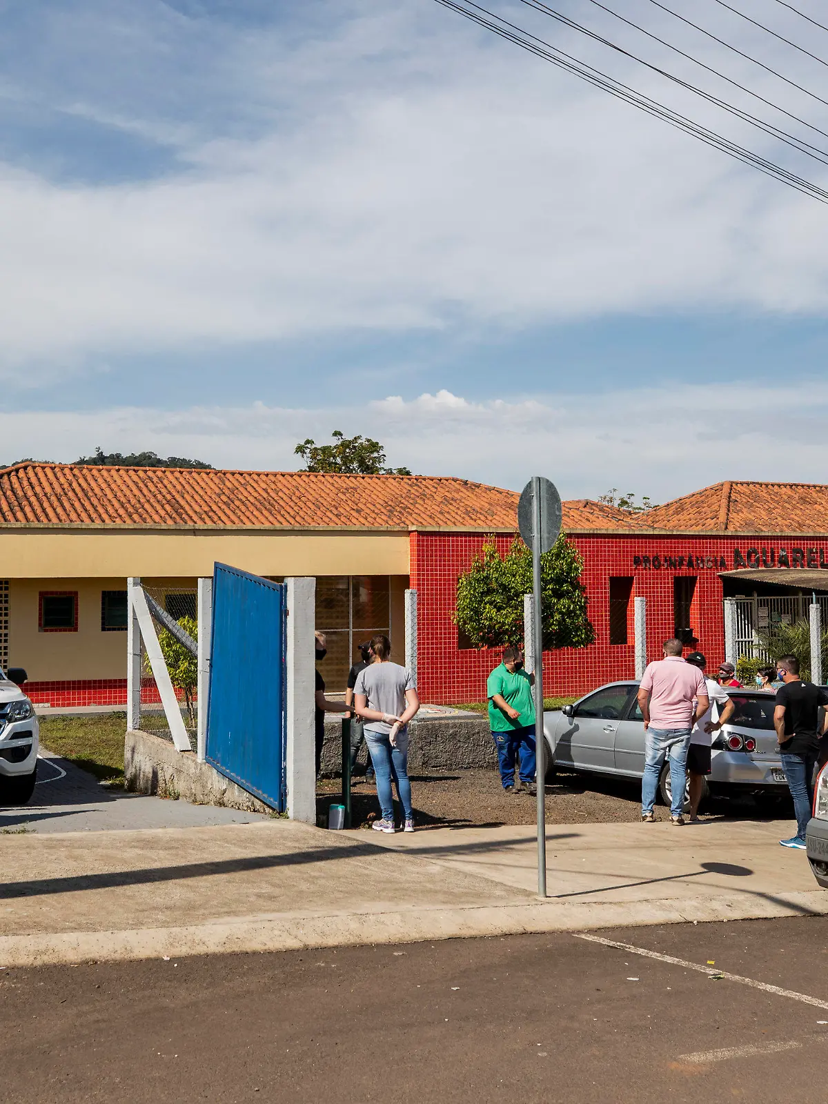 Relatives stand outside the Aquarela preschool in Saudades, in the southern state of Santa Catarina, Brazil, Tuesday, May 4, 2021. According to police an 18-year-old teenager entered the day care center with a knife and stabbed and killed three children and a teacher. (AP Photo/Liamara Polli)