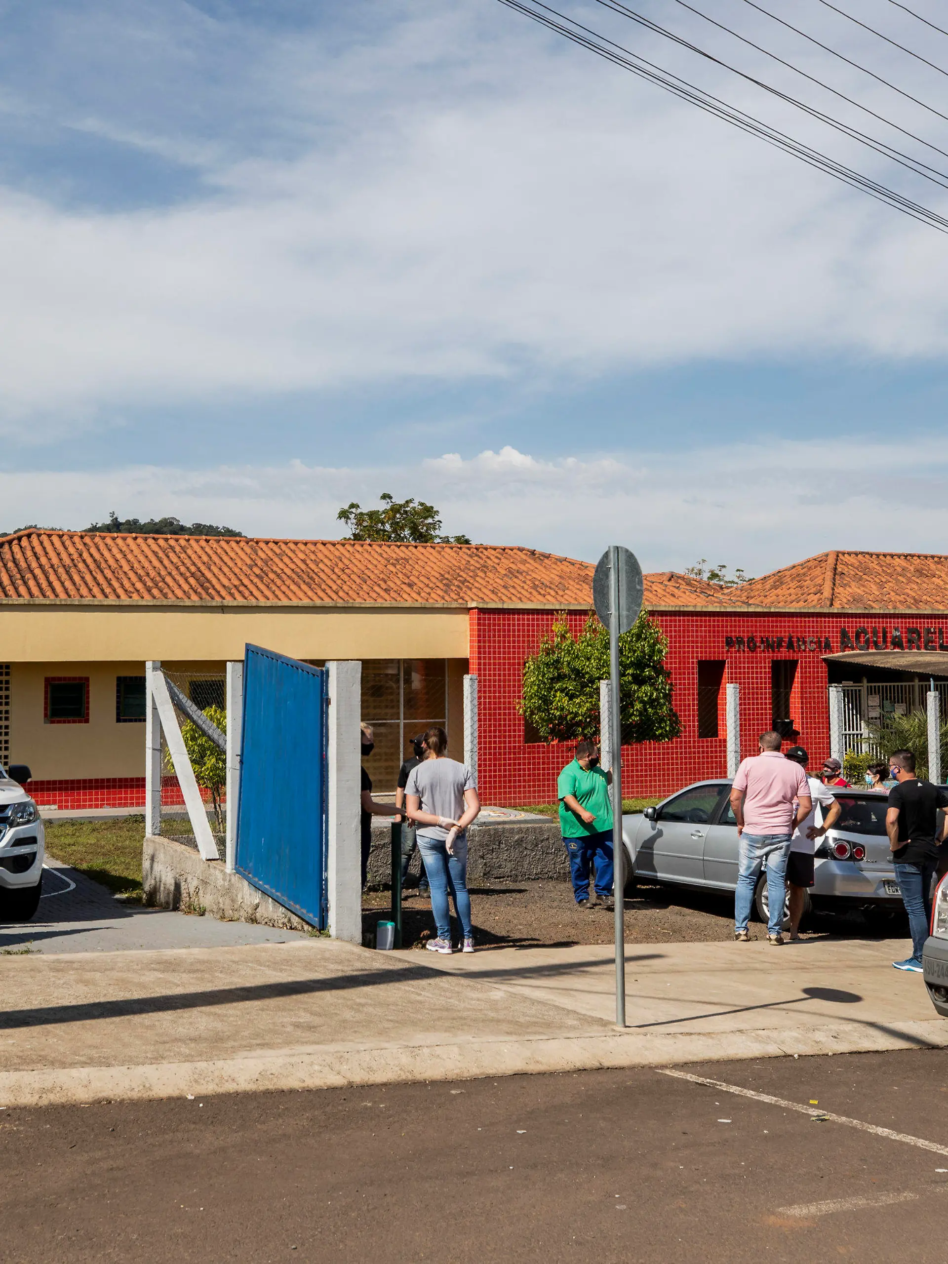 Relatives stand outside the Aquarela preschool in Saudades, in the southern state of Santa Catarina, Brazil, Tuesday, May 4, 2021. According to police an 18-year-old teenager entered the day care center with a knife and stabbed and killed three children and a teacher. (AP Photo/Liamara Polli)