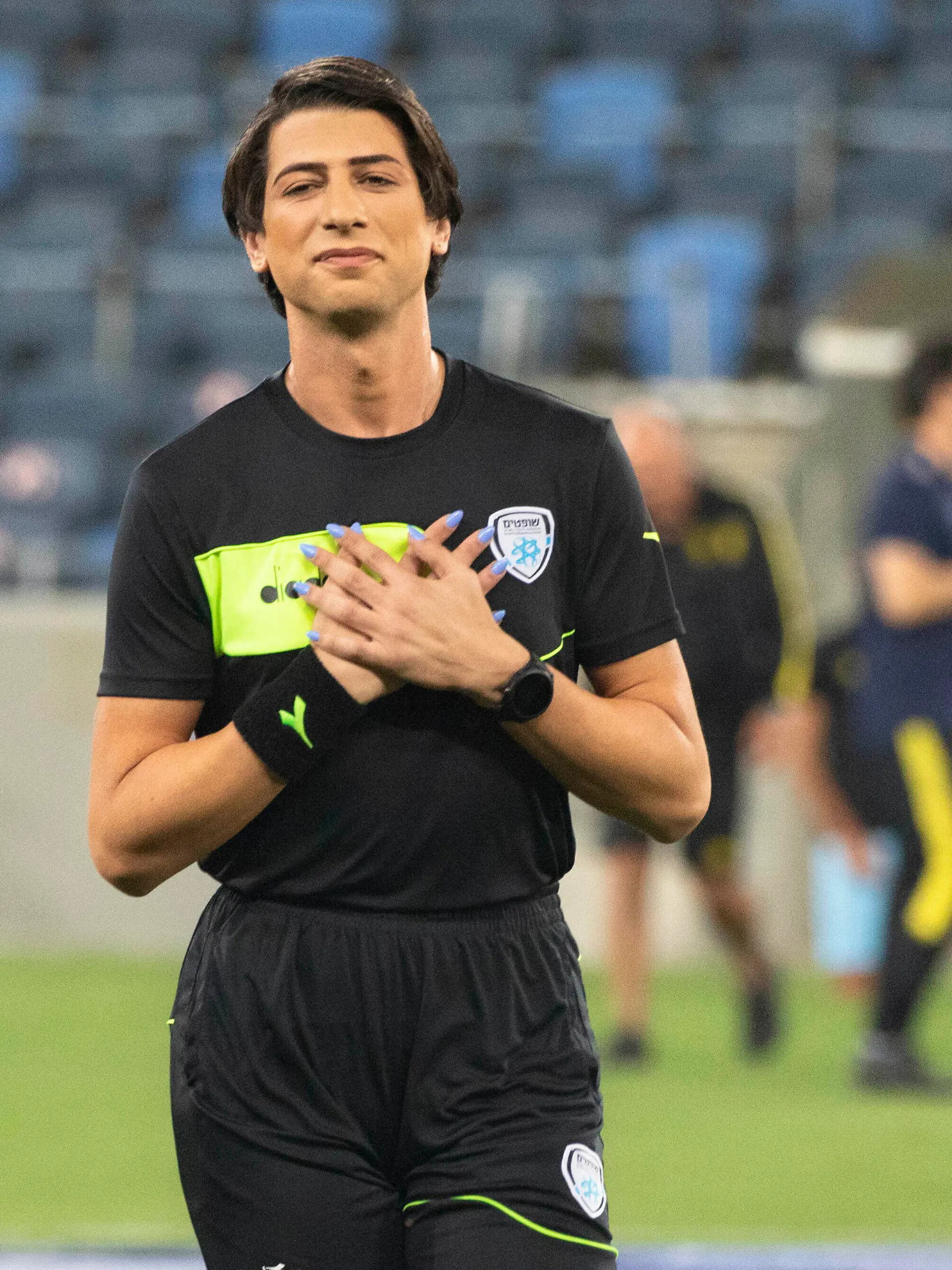 Referee Sapir Berman attends a warm-up before an Israeli Premier League soccer match between Hapoel Haifa and Beitar Jerusalem in the northern Israeli city of Haifa, Monday, May 3, 2021. Israeli soccer's first transgender soccer referee took the field Monday for the first time since coming out publicly as a woman last week. (AP Photo/Sebastian Scheiner)