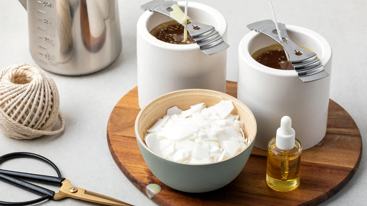 Ingredients and tools for handmade aroma candles. Organic soy wax, essential oils, wicks, pots. Craft hobby, small business, artisan products concept
