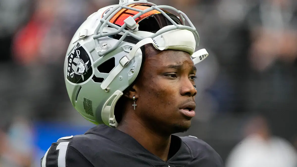 FILE - Las Vegas Raiders wide receiver Henry Ruggs III walks on the field before an NFL football game against the Chicago Bears, Oct. 10, 2021, in Las Vegas. Police in Las Vegas said Ruggs is facing a driving under the influence charge after a fiery vehicle crash early Tuesday, Nov. 2, 2021, that left a woman dead and Ruggs and his female passenger injured. (AP Photo/Rick Scuteri, File)