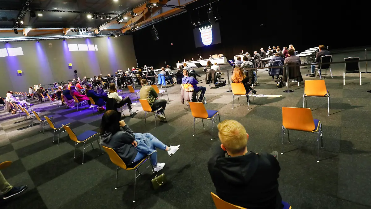 People sit inside the hall on the fairground of Messe Kassel, converted into a court room, on the opening day of the trial against Maurice P., who crashed his car into a carnival parade injuring several people in Volkmarsen on February 25, 2020, in Kassel, Germany, May 3, 2021. REUTERS/Ralph Orlowski