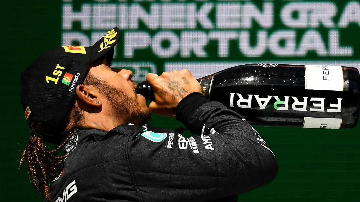 PORTIMAO, PORTUGAL - MAY 02: Race winner Lewis Hamilton of Great Britain and Mercedes GP celebrates with sparkling wine on the podium during the F1 Grand Prix of Portugal at Autodromo Internacional Do Algarve on May 02, 2021 in Portimao, Portugal. (Photo by Gabriel Bouys - Pool/Getty Images)