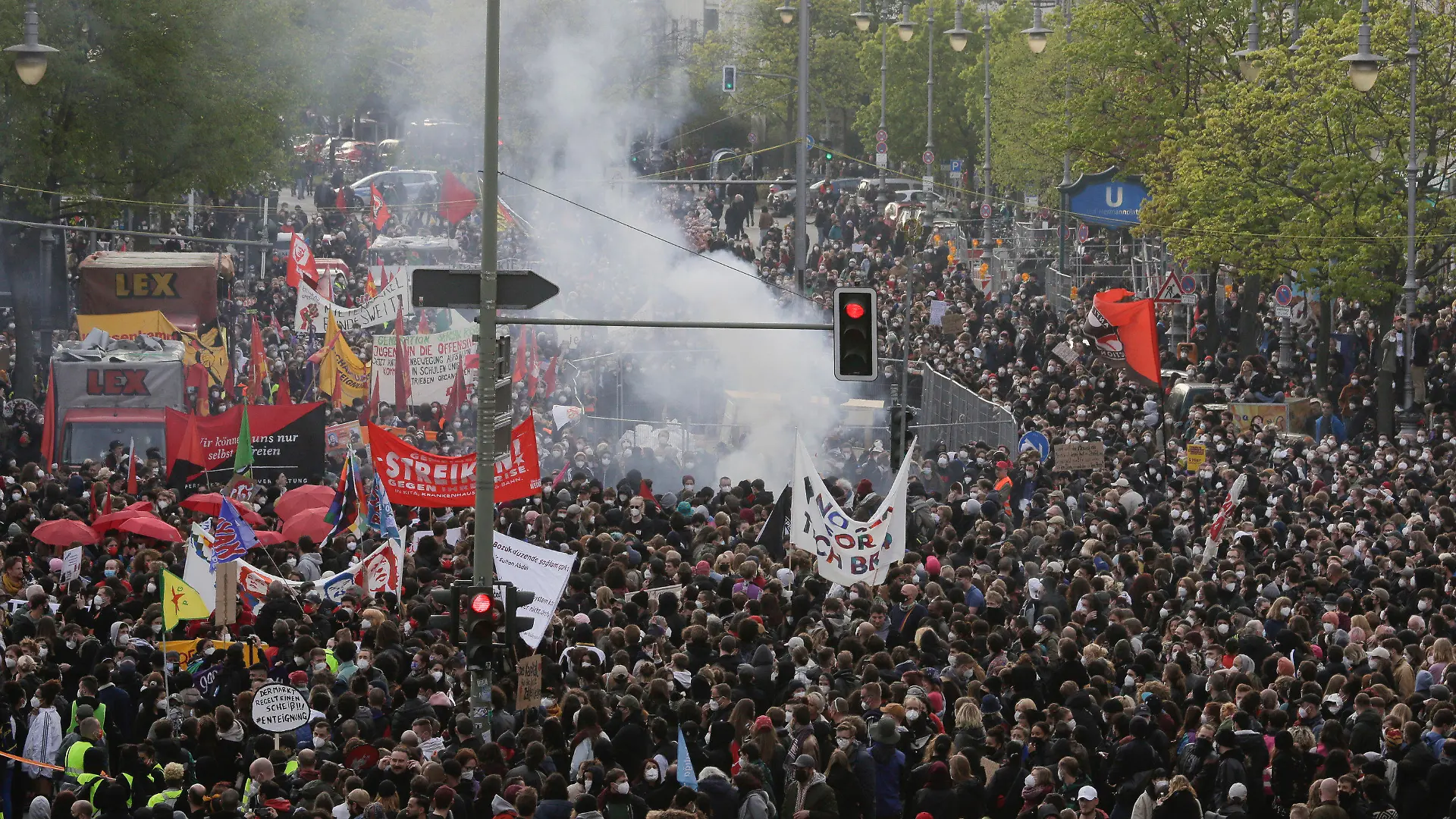 Smoke from fireworks rise at a May Day rally at the Hermannplatz square in Berlin, Germany, Saturday, May 1, 2021. (AP Photo/Markus Schreiber)