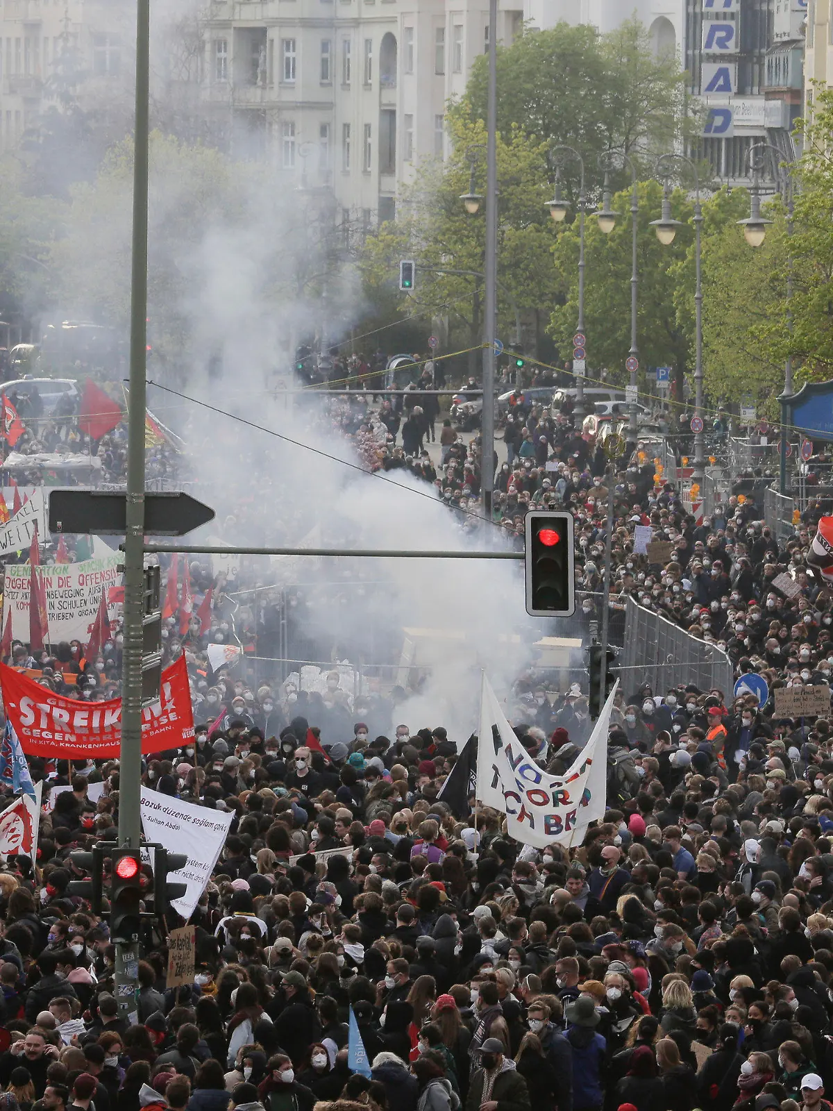 Smoke from fireworks rise at a May Day rally at the Hermannplatz square in Berlin, Germany, Saturday, May 1, 2021. (AP Photo/Markus Schreiber)