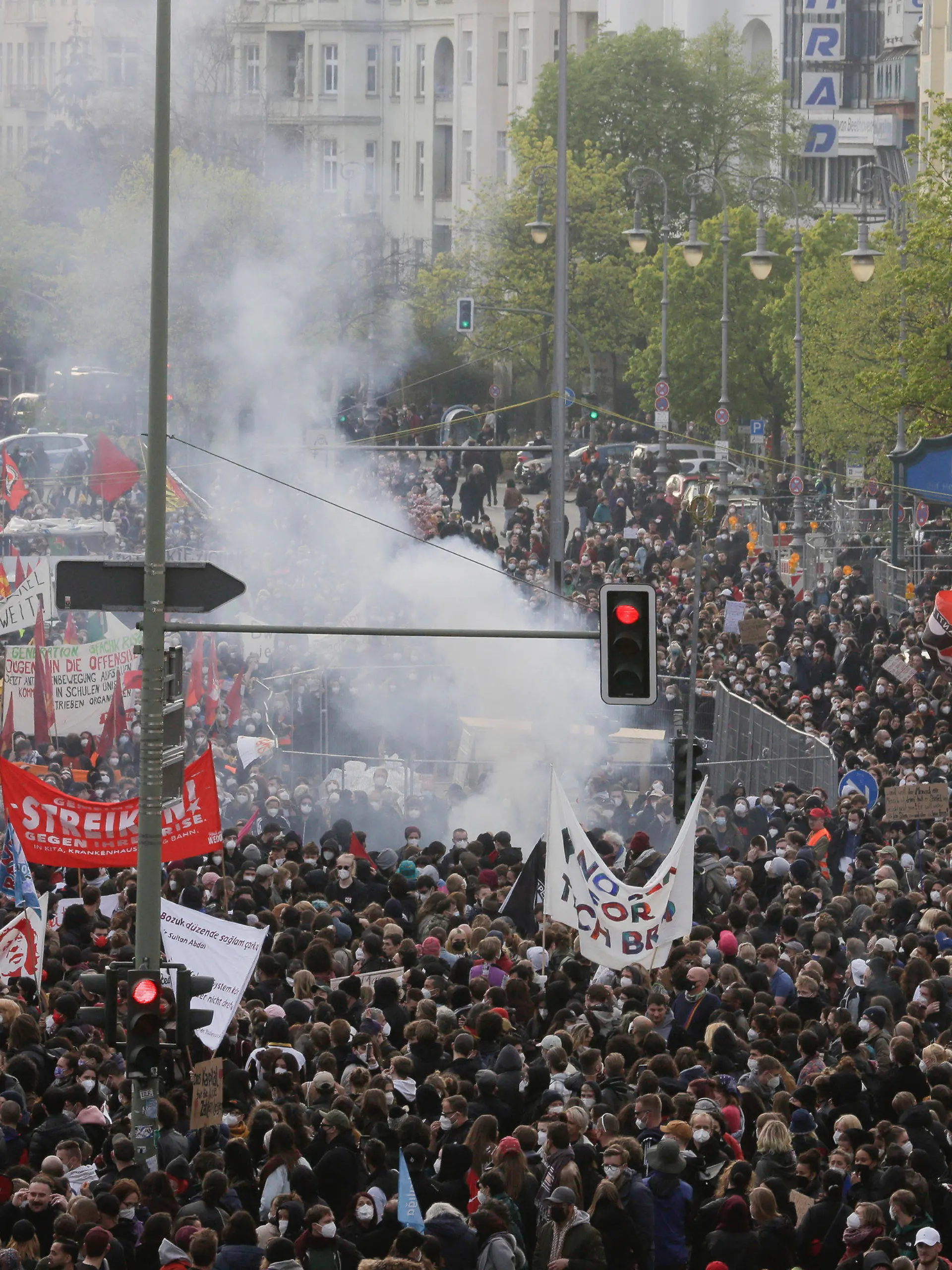 Smoke from fireworks rise at a May Day rally at the Hermannplatz square in Berlin, Germany, Saturday, May 1, 2021. (AP Photo/Markus Schreiber)