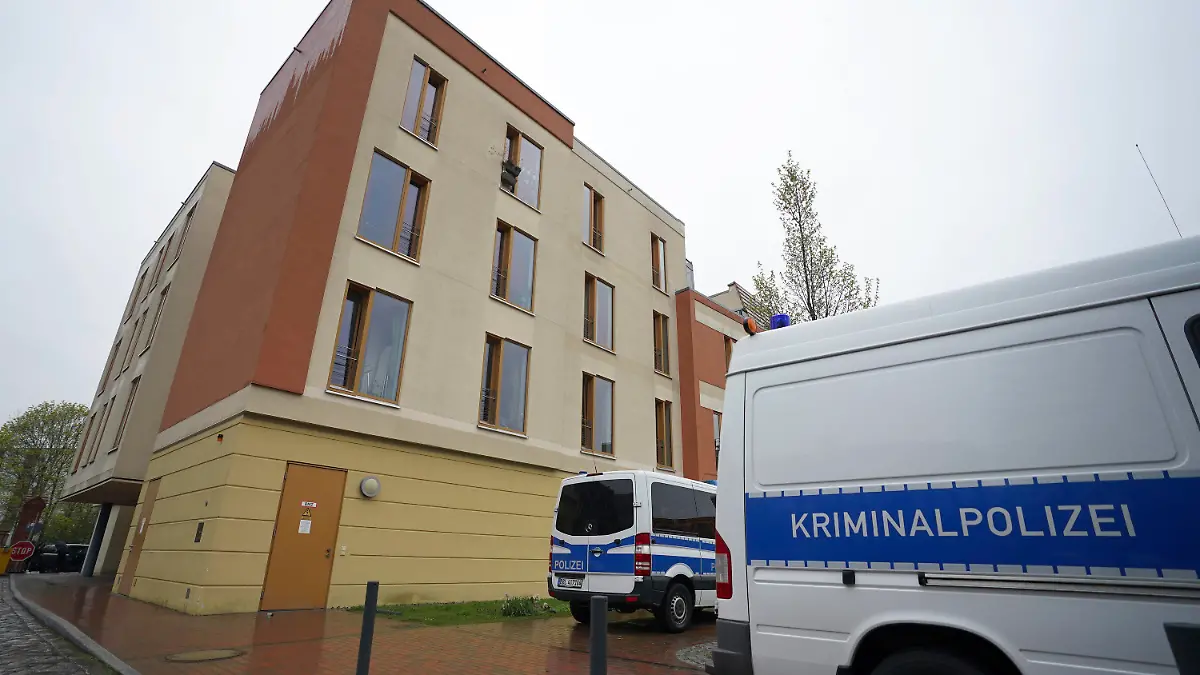 Police cars are perked behind the 'Thusnelda von Saldern Haus' at the Oberlinklinik (Oberlin Clinic) in Potsdam near Berlin, Germany, Thursday, April 29, 2021. German police say a woman has been detained after four people were found dead at a hospital in the eastern city of Potsdam. (AP Photo/Michael Sohn)