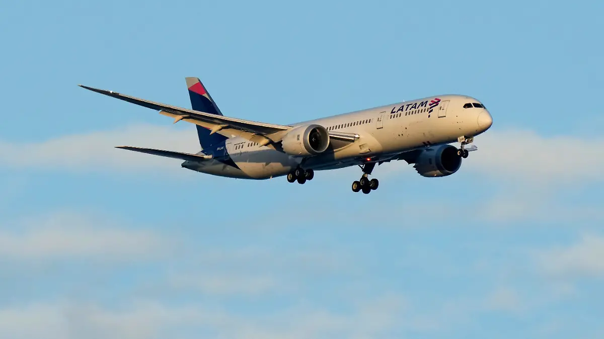 A LATAM Airlines Boeing 787 approaches for landing in Lisbon at sunrise, Wednesday, July 5, 2023. (AP Photo/Armando Franca)