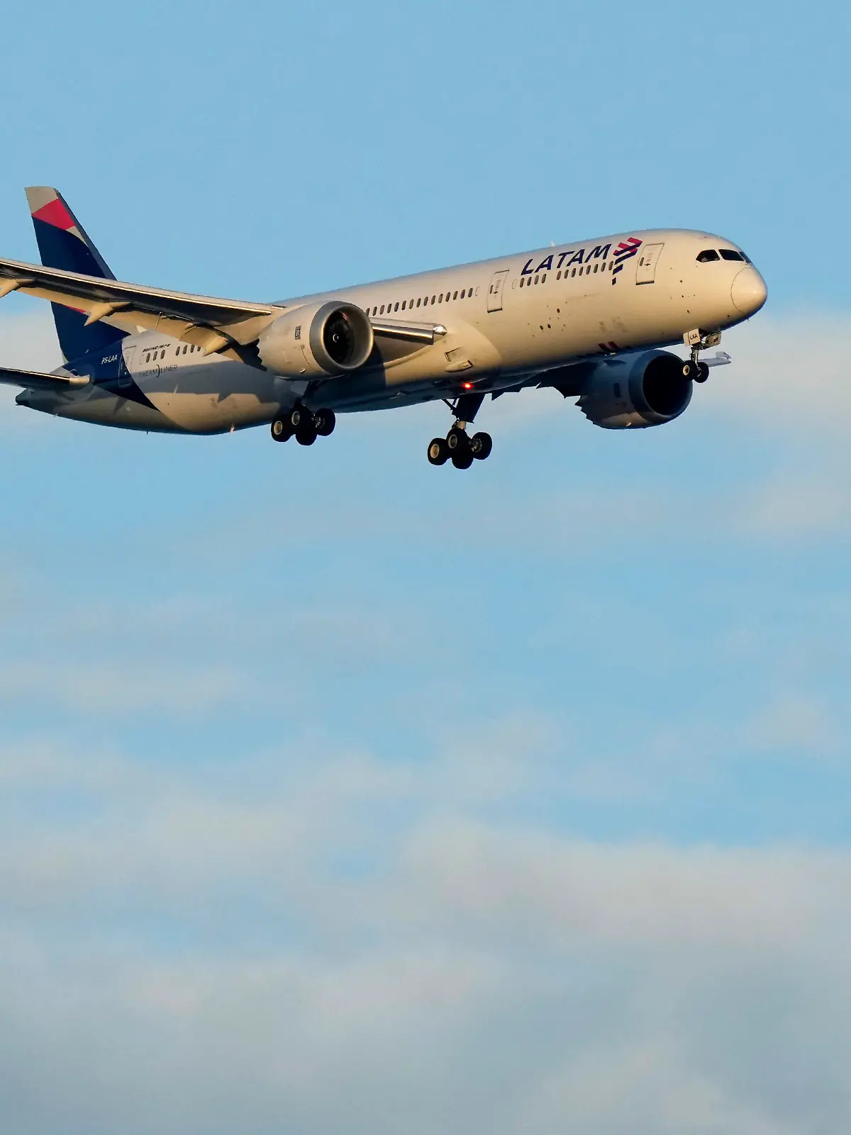 A LATAM Airlines Boeing 787 approaches for landing in Lisbon at sunrise, Wednesday, July 5, 2023. (AP Photo/Armando Franca)