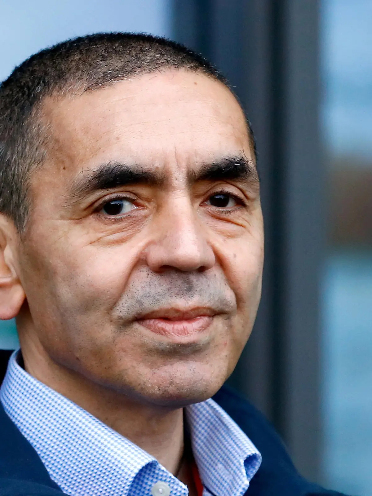 FILE PHOTO: CEO and co-founder of BioNTech, Ugur Sahin, answers journalists' questions after the European Medicines Agency (EMA) approved its COVID-19 vaccine, at the company headquarters in Mainz, Germany December 22, 2020. REUTERS/Ralph Orlowski/File Photo