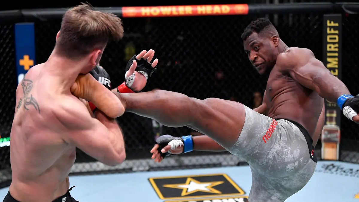 Mar 27, 2021; Las Vegas, NV, USA; Francis Ngannou of Cameroon kicks Stipe Miocic in their UFC heavyweight championship fight during the UFC 260 event at UFC APEX on March 27, 2021 in Las Vegas, Nevada.   Mandatory Credit: Jeff Bottari/Handout Photo via USA TODAY Sports