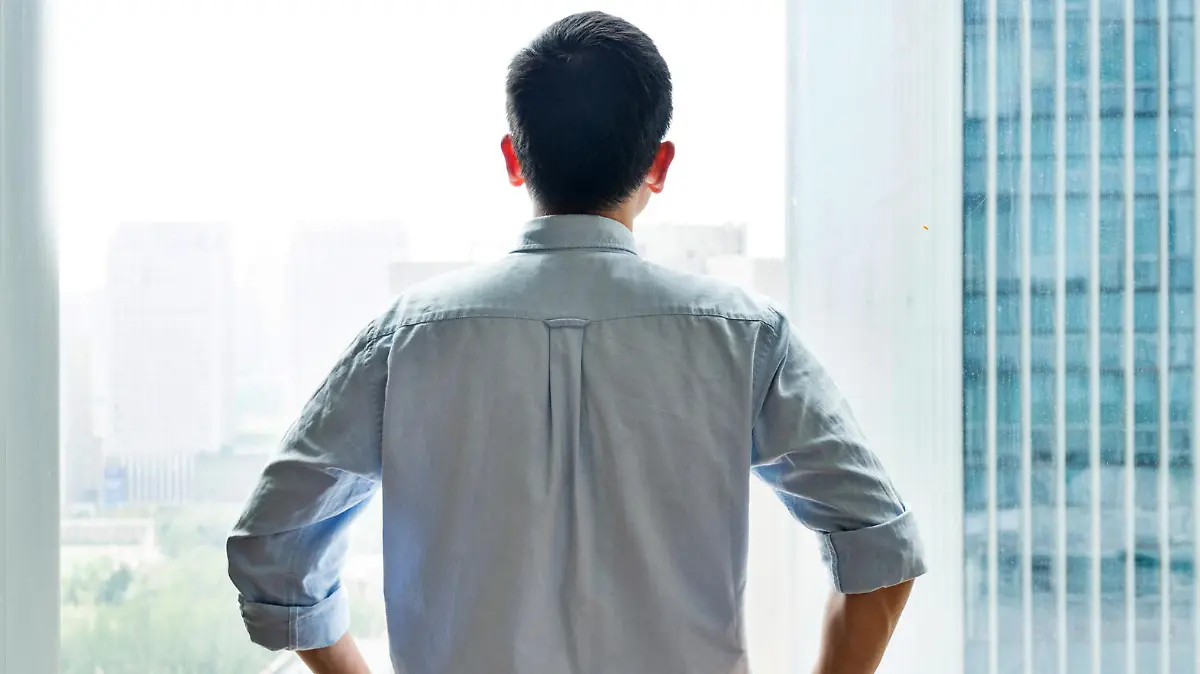 Businessman standing and looking at cityscape