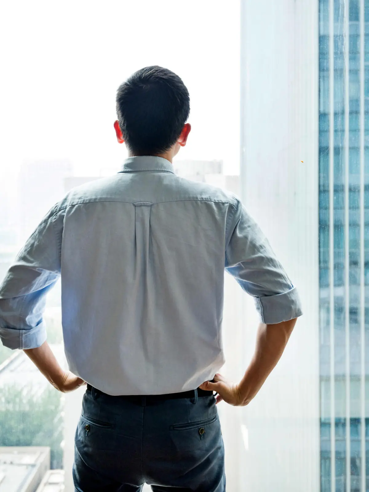 Businessman standing and looking at cityscape