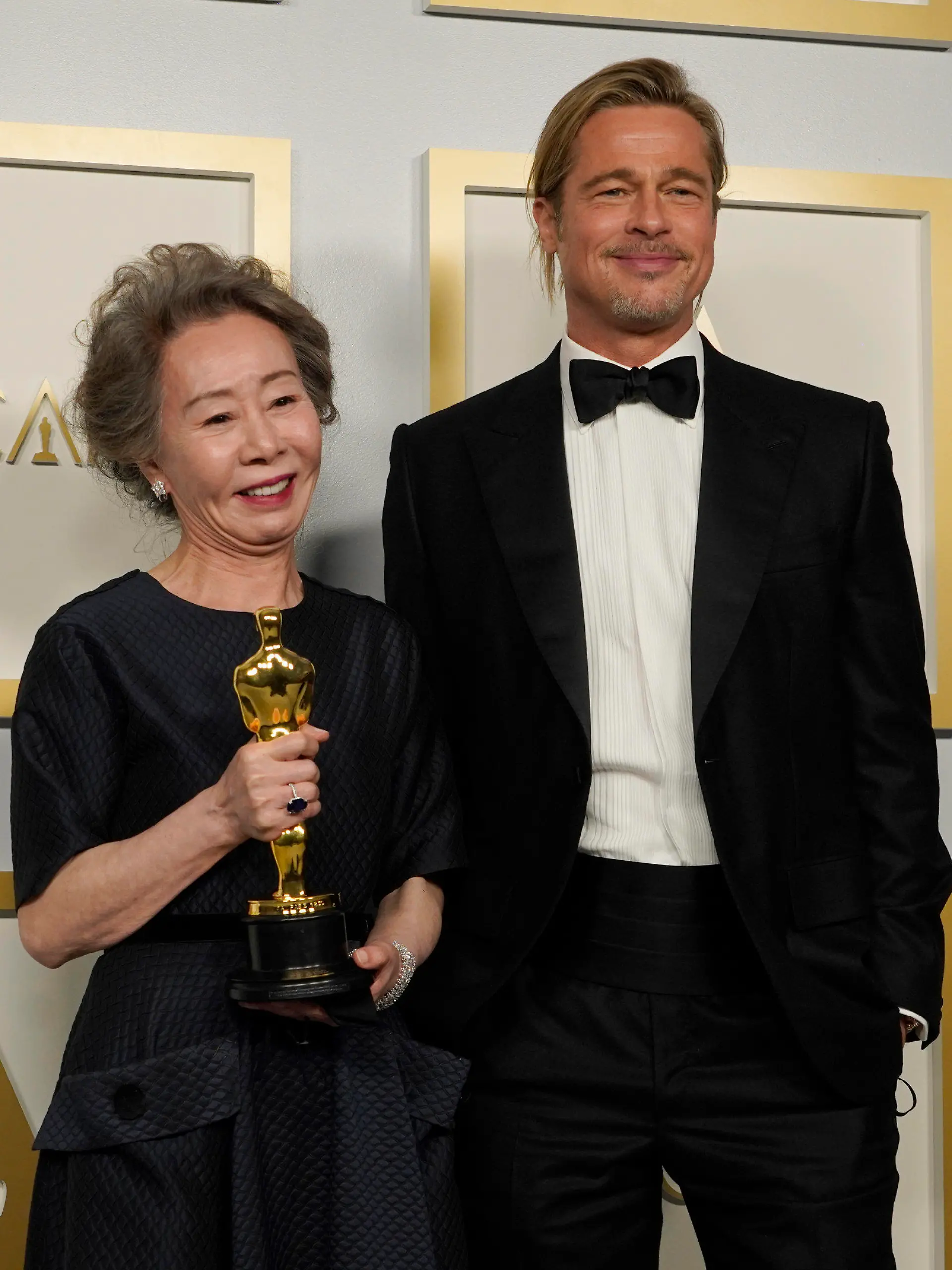 Brad Pitt, right, poses with Yuh-Jung Youn, winner of the award for best actress in a supporting role for "Minari," in the press room at the Oscars on Sunday, April 25, 2021, at Union Station in Los Angeles. (AP Photo/Chris Pizzello, Pool)