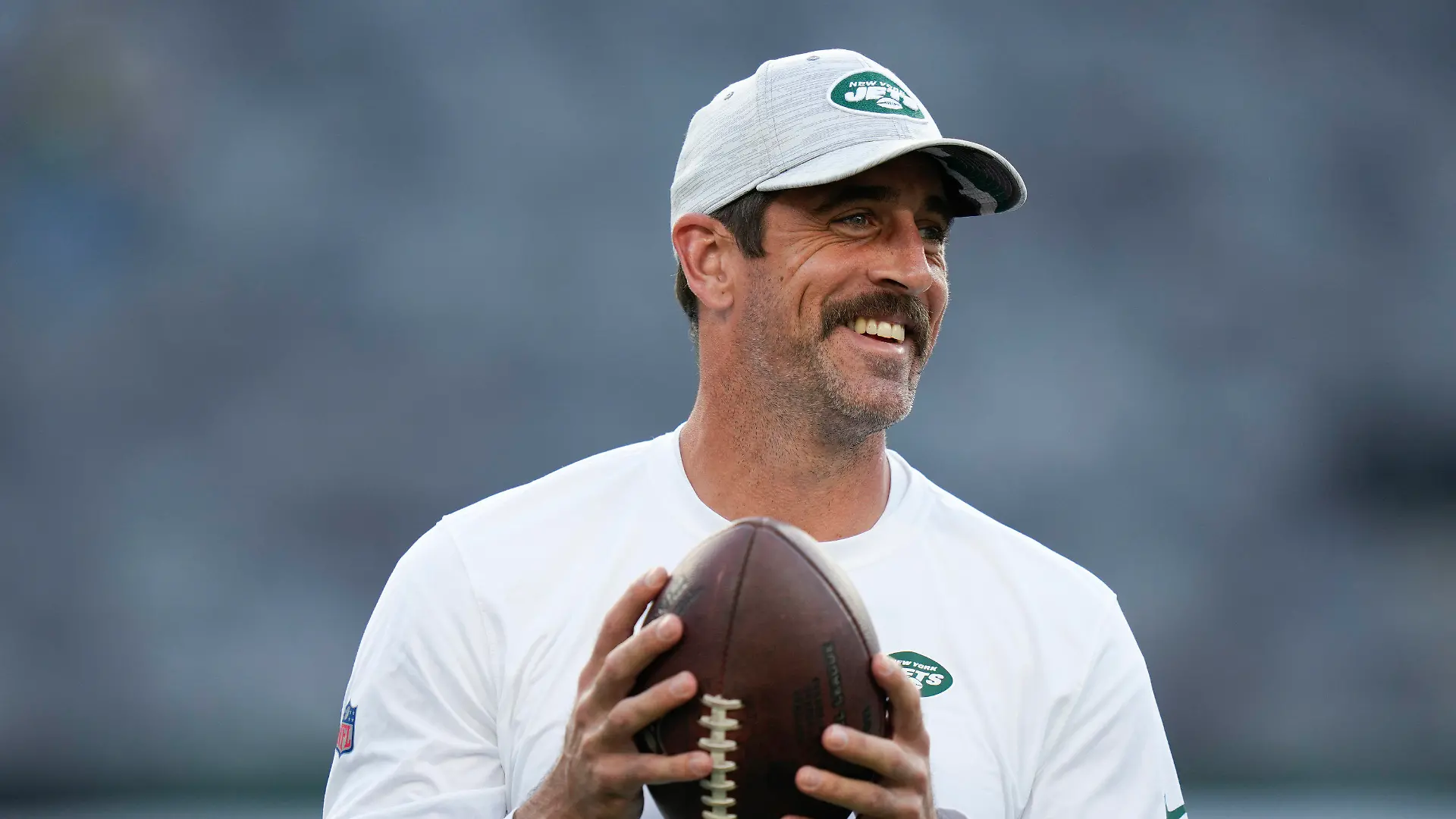 FILE - New York Jets quarterback Aaron Rodgers walks on the field during warm-ups before an NFL football game against the Tampa Bay Buccaneers, Saturday, Aug. 19, 2023, in East Rutherford, N.J. He’ll become a folk hero if he can lead the Jets to a Super Bowl for the first time since Broadway Joe Namath.(AP Photo/Seth Wenig, File)