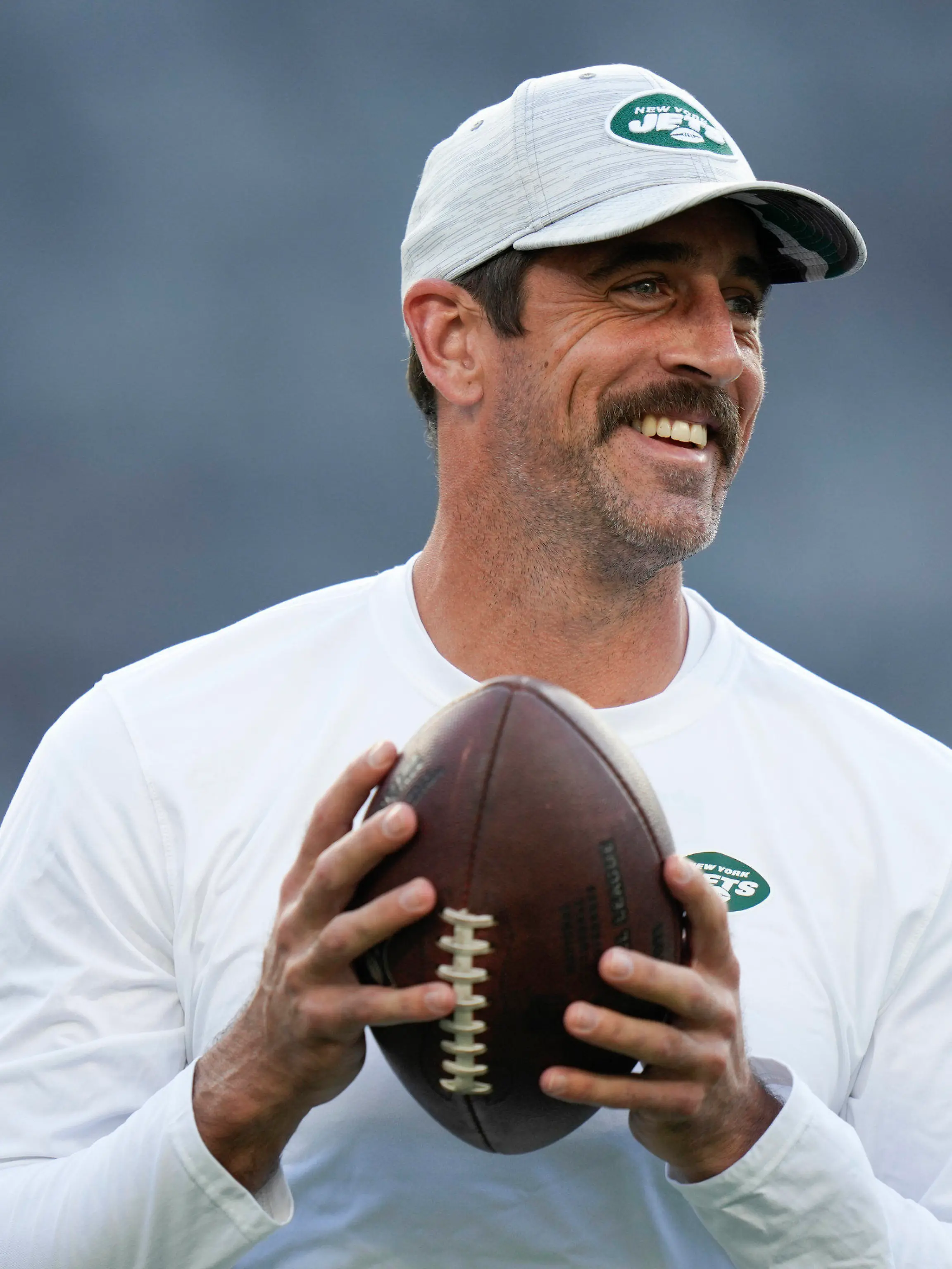 FILE - New York Jets quarterback Aaron Rodgers walks on the field during warm-ups before an NFL football game against the Tampa Bay Buccaneers, Saturday, Aug. 19, 2023, in East Rutherford, N.J. He’ll become a folk hero if he can lead the Jets to a Super Bowl for the first time since Broadway Joe Namath.(AP Photo/Seth Wenig, File)