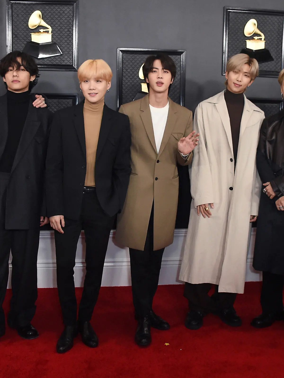 FILE - In this Jan. 26, 2020, file photo, South Korean K-pop band BTS arrives for the 62nd annual Grammy Awards in Los Angeles. BTS released a statement condemning racism against Asians and Asian Americans and Pacific Islanders (AAPI) on Tuesday, March 30, 2021. “We stand against racial discrimination,” the biggest boyband in the world, tweeted to their 34 million followers in both English and Korean.  (Photo by Jordan Strauss/Invision/AP, File)