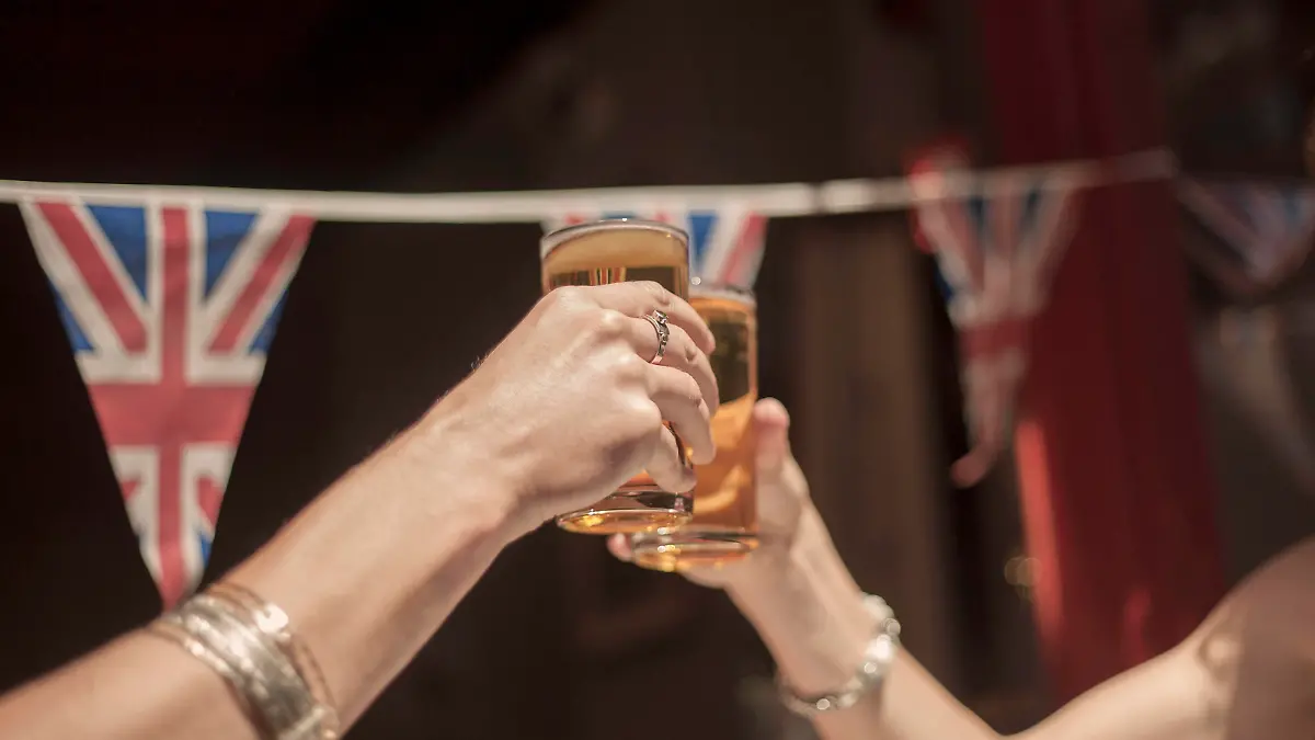 Female friends toasting beer glasses while enjoying weekend at pub model released Symbolfoto property released AJOF00162