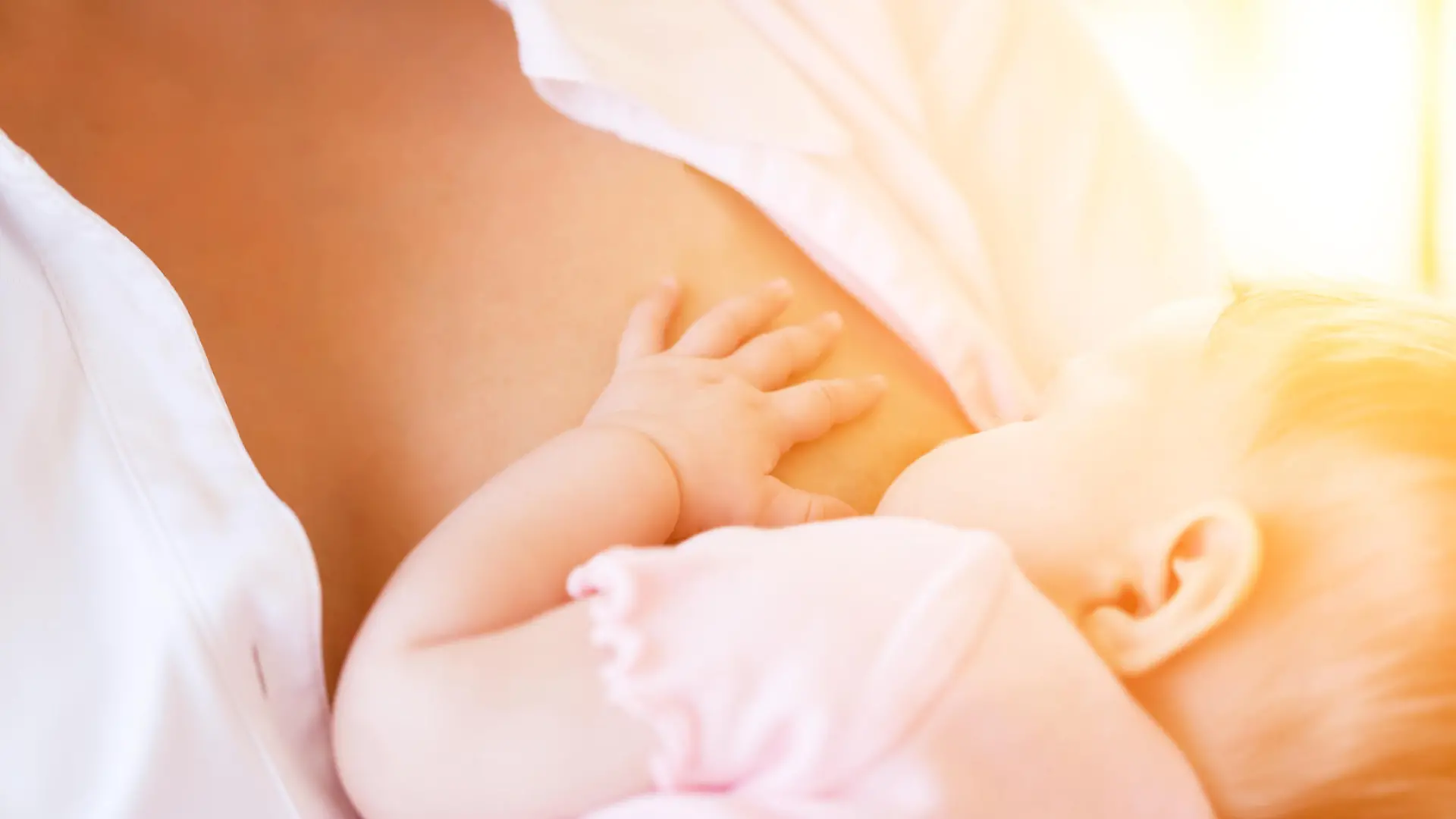 Mother nursing baby by breastfeeding