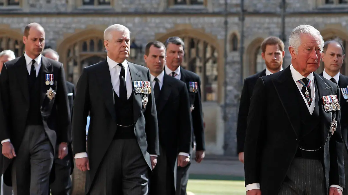 From front left, Britain's Prince Charles, Princess Anne, Prince Andrew. Prince Edward, Prince William, Peter Phillips, Prince Harry, Earl of Snowdon and Tim Laurence follow the coffin in a ceremonial procession for the funeral of Britain's Prince Philip inside Windsor Castle in Windsor, England Saturday April 17, 2021. Prince Philip died April 9 at the age of 99 after 73 years of marriage to Britain's Queen Elizabeth II. (Alastair Grant/Pool via AP)
