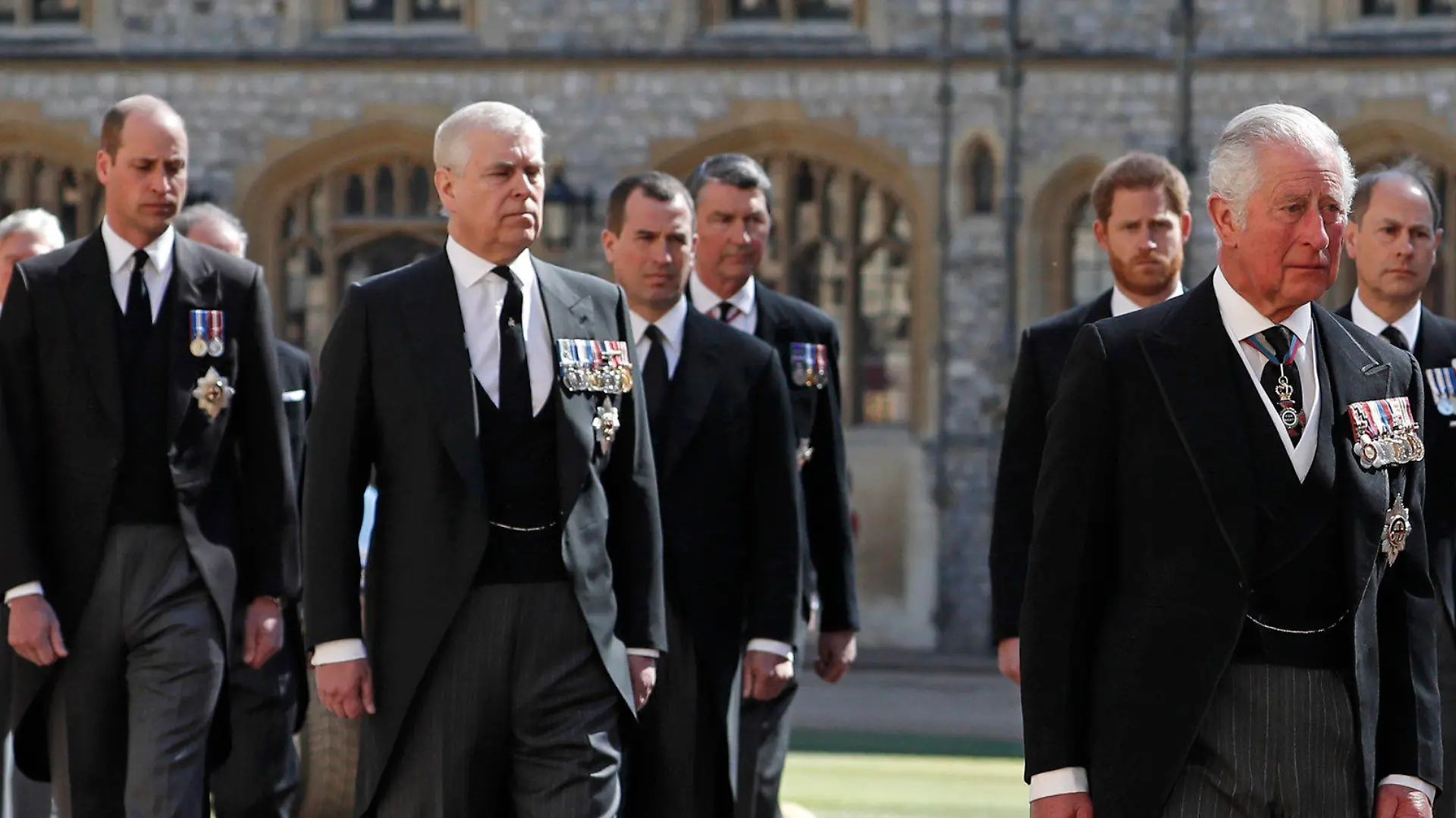 From front left, Britain's Prince Charles, Princess Anne, Prince Andrew. Prince Edward, Prince William, Peter Phillips, Prince Harry, Earl of Snowdon and Tim Laurence follow the coffin in a ceremonial procession for the funeral of Britain's Prince Philip inside Windsor Castle in Windsor, England Saturday April 17, 2021. Prince Philip died April 9 at the age of 99 after 73 years of marriage to Britain's Queen Elizabeth II. (Alastair Grant/Pool via AP)