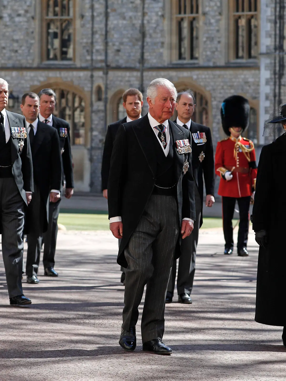 From front left, Britain's Prince Charles, Princess Anne, Prince Andrew. Prince Edward, Prince William, Peter Phillips, Prince Harry, Earl of Snowdon and Tim Laurence follow the coffin in a ceremonial procession for the funeral of Britain's Prince Philip inside Windsor Castle in Windsor, England Saturday April 17, 2021. Prince Philip died April 9 at the age of 99 after 73 years of marriage to Britain's Queen Elizabeth II. (Alastair Grant/Pool via AP)