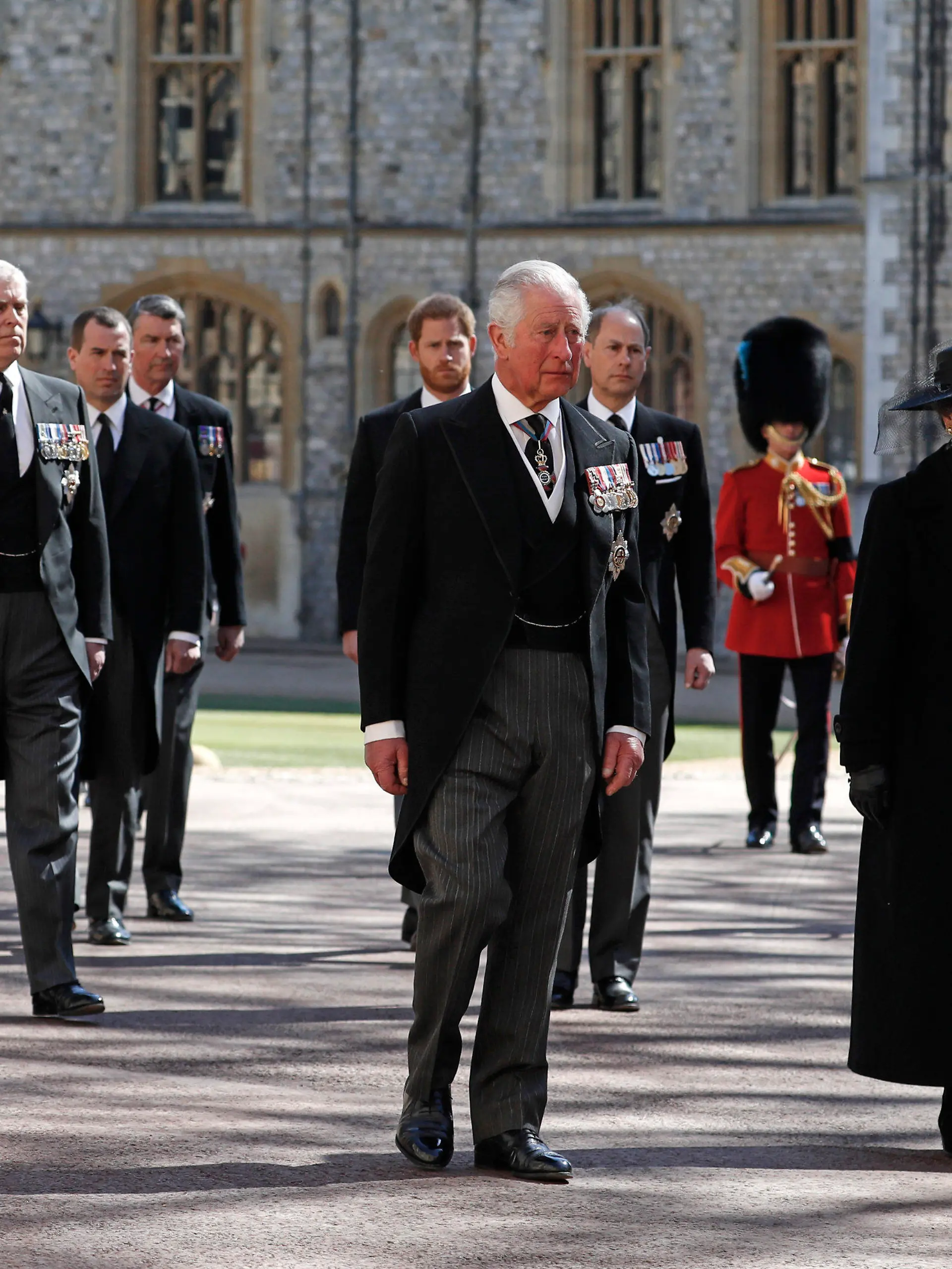 From front left, Britain's Prince Charles, Princess Anne, Prince Andrew. Prince Edward, Prince William, Peter Phillips, Prince Harry, Earl of Snowdon and Tim Laurence follow the coffin in a ceremonial procession for the funeral of Britain's Prince Philip inside Windsor Castle in Windsor, England Saturday April 17, 2021. Prince Philip died April 9 at the age of 99 after 73 years of marriage to Britain's Queen Elizabeth II. (Alastair Grant/Pool via AP)