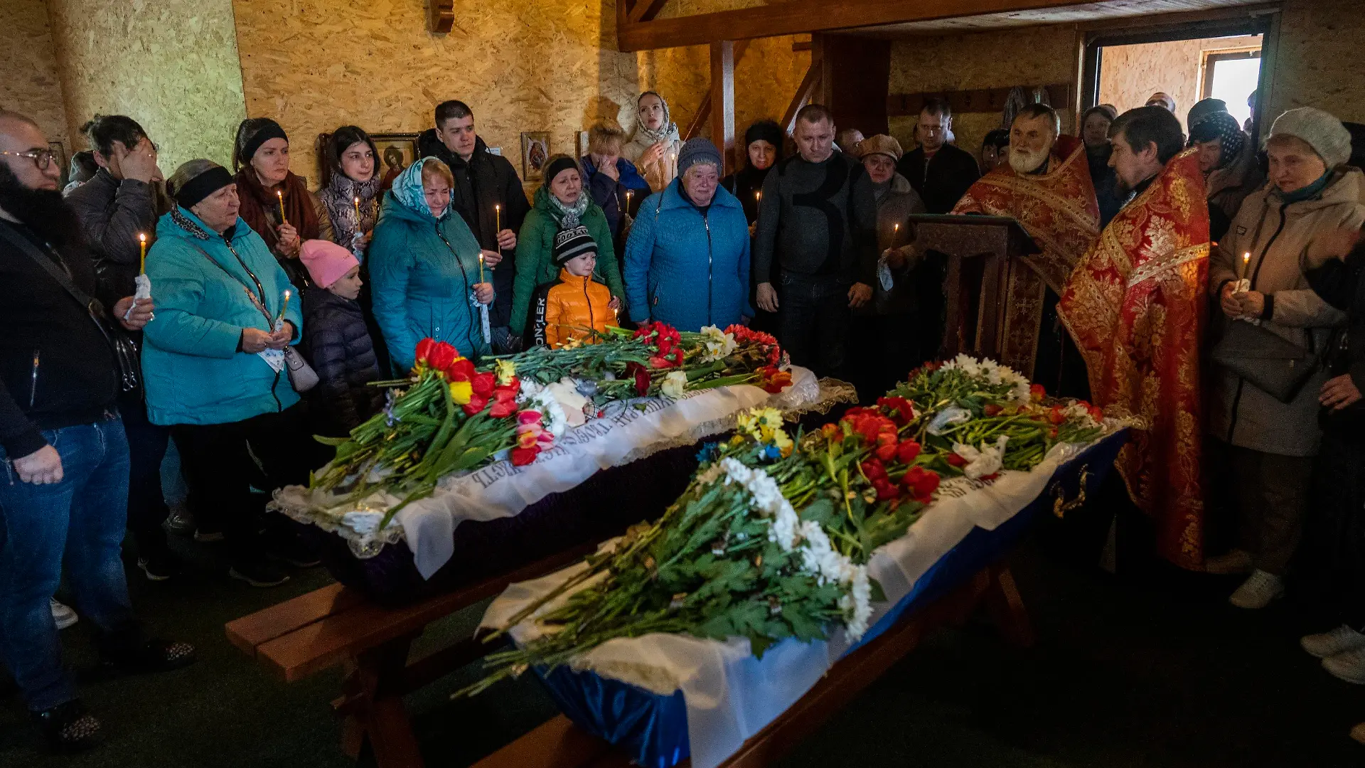 Relatives and family friends attend the funeral of Sofia Shulha, 12, and Pysarev Kiriusha, 18, in Uman, central Ukraine, Sunday, April 30, 2023. Shulha and Kiriusha were killed during a Russian attack on a residential building early Friday morning. (AP Photo/Bernat Armangue)