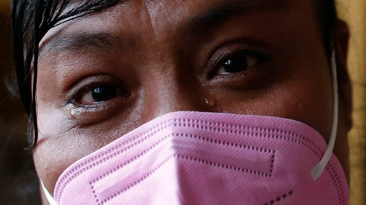 Sex worker Elena sheds tears as she describes the family sexual abuse and trafficking that led her into a life of prostitution starting at age 15, at the offices of Brigada Callejera or "The Street Brigade", in central Mexico City, Saturday, March 6, 2021. The 39-year-old mother of four says her older children know her profession and don't judge her for it, "I do it out of necessity, and love for my children, because we as parents have the responsibility to make our children's lives better." (AP Photo/Rebecca Blackwell)