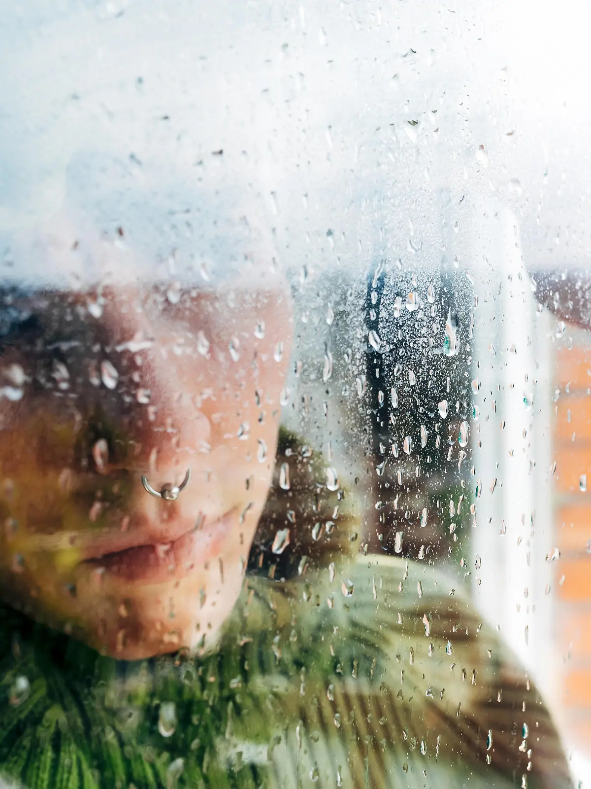 Melancholic young woman looking through window Copyright: xAlbertoxMenendezx