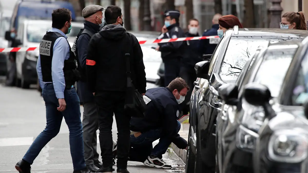 French police investigate the scene after one person was shot dead and one injured in front of the Henry Dunant hospital in Paris, France, April 12, 2021. REUTERS/Benoit Tessier