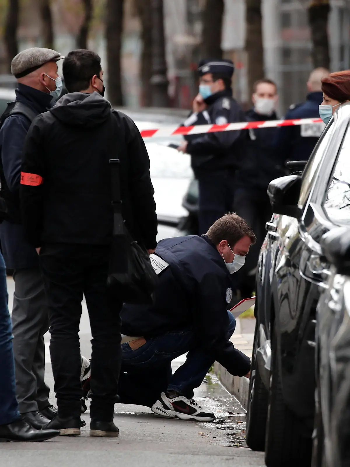 French police investigate the scene after one person was shot dead and one injured in front of the Henry Dunant hospital in Paris, France, April 12, 2021. REUTERS/Benoit Tessier