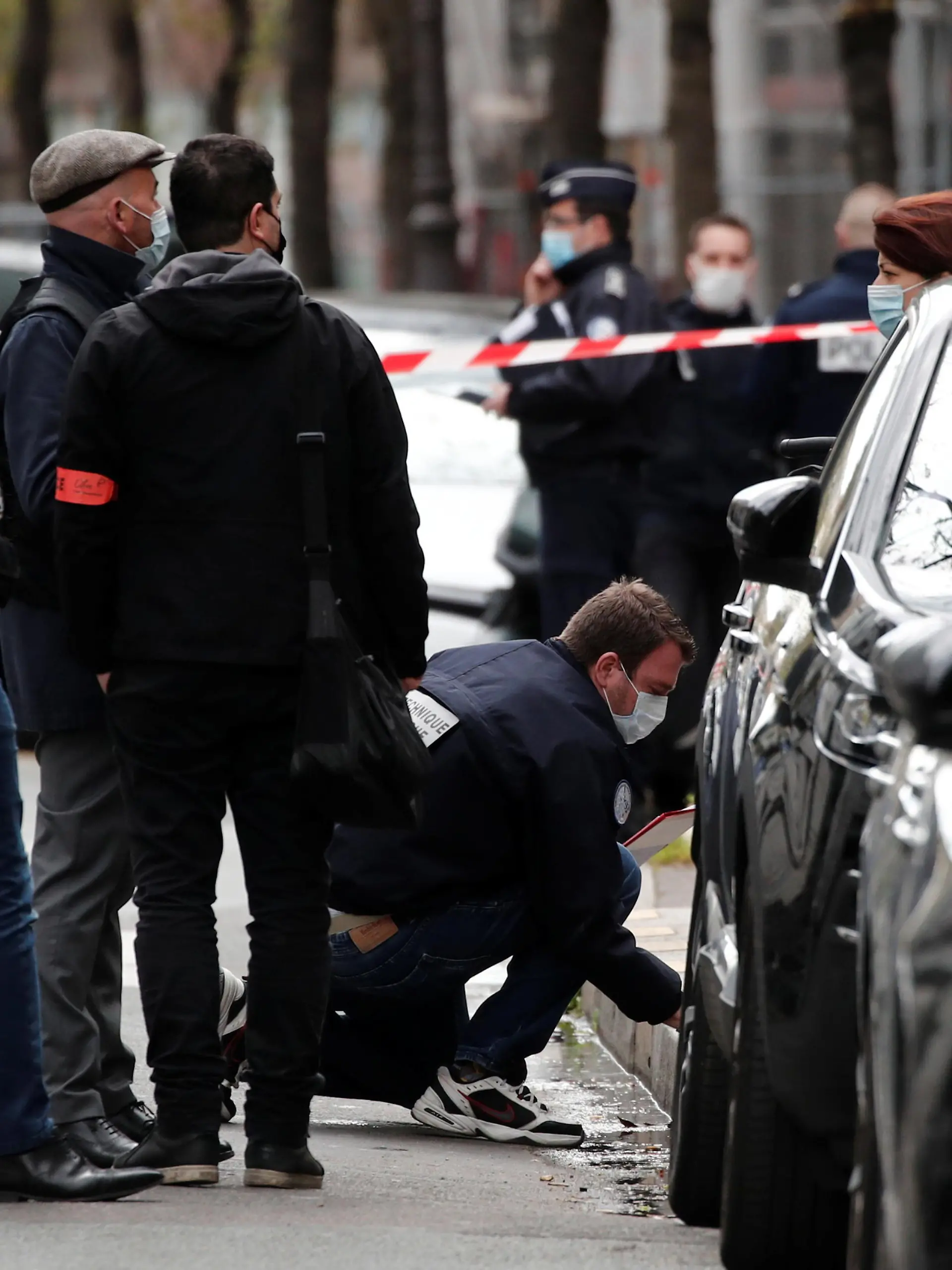French police investigate the scene after one person was shot dead and one injured in front of the Henry Dunant hospital in Paris, France, April 12, 2021. REUTERS/Benoit Tessier