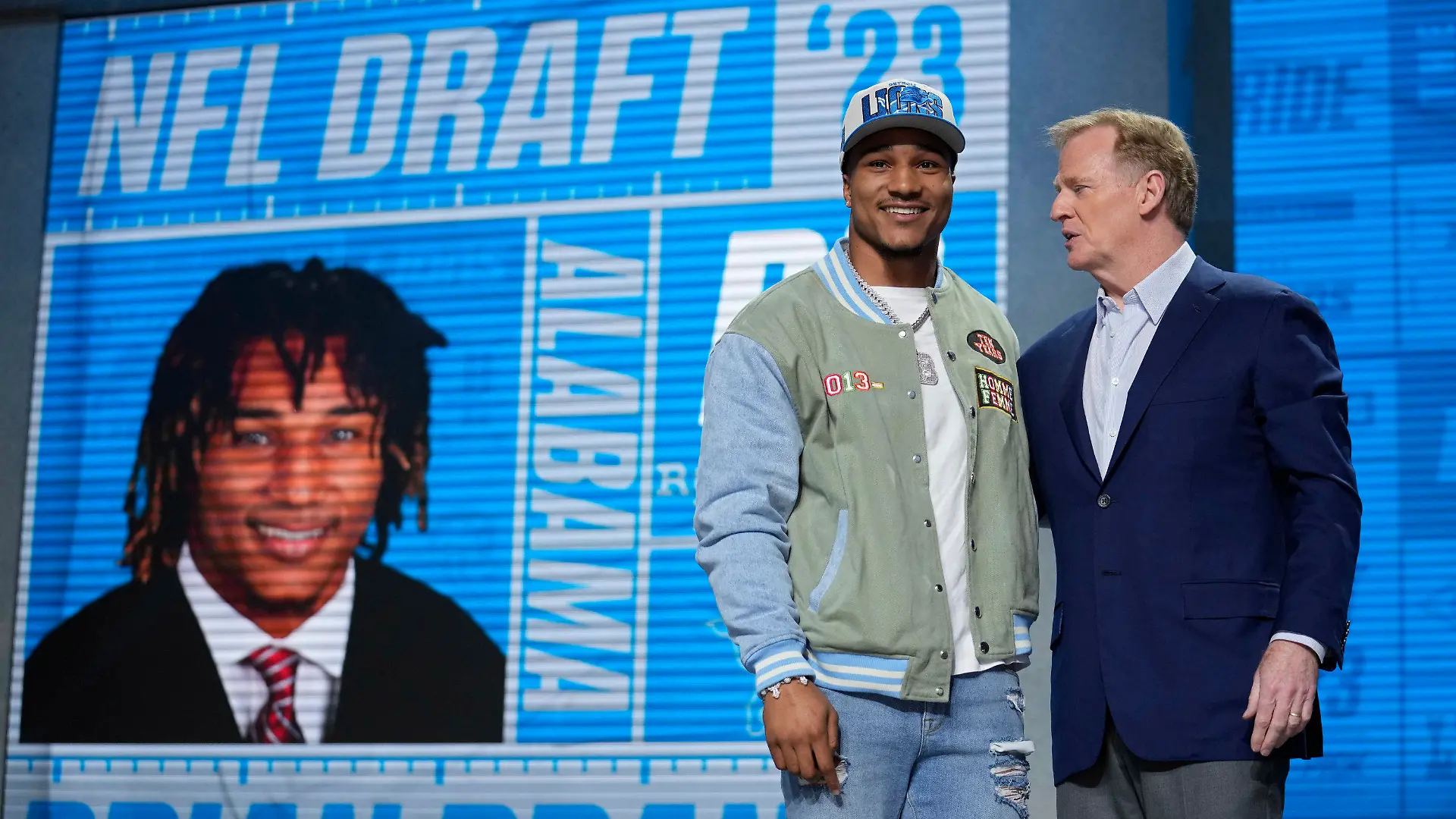 Alabama defensive back Brian Branch, left, stands with NFL Commissioner Roger Goodell after being chosen by the Detroit Lions during the second round of the NFL football draft, Friday, April 28, 2023, in Kansas City, Mo. (AP Photo/Jeff Roberson)