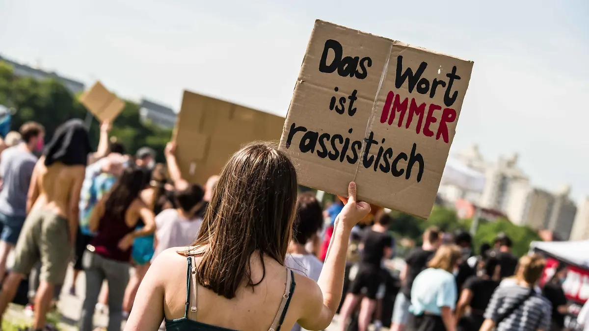 June 27, 2020, Munich, Bavaria, Germany: ''The word is always racist'' held by a demonstrator against the ongoing use of the N-word in Germany. In the wake of the killing of George Floyd and numerous other cases of police brutality and killings against People of Color, over 500 assembled in Munich, Germany to protest against the use of the so-called N-Word. In Germany, the continued use of the N-Word is defended by mainstream politicians, police, right-extremists, Pegida, Neonazis, and the middle of society, despite blacks stating the use is racist derogatory, and exclusionary. Recently, a police officer in Stuttgart was caught using the German slur ''Kanaken'' for non-whites. (Credit Image: Â© Sachelle Babbar/ZUMA Wire