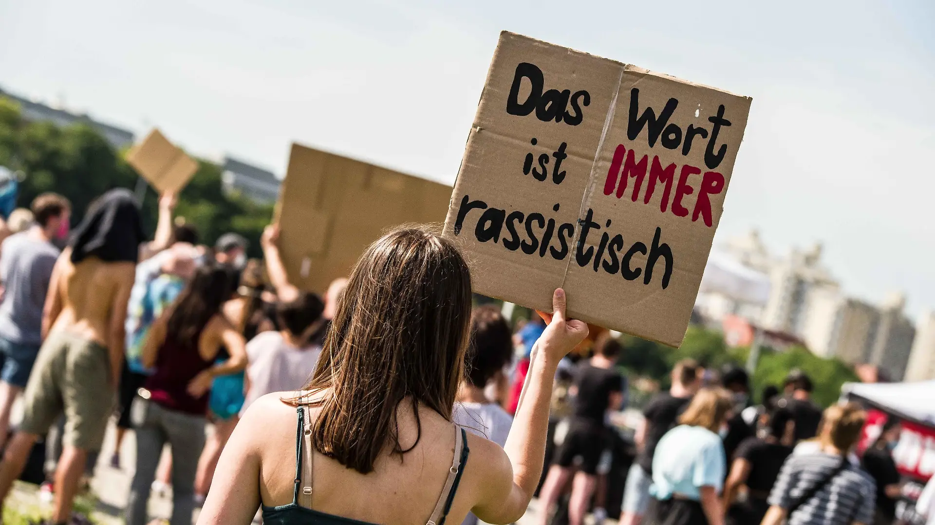 June 27, 2020, Munich, Bavaria, Germany: ''The word is always racist'' held by a demonstrator against the ongoing use of the N-word in Germany. In the wake of the killing of George Floyd and numerous other cases of police brutality and killings against People of Color, over 500 assembled in Munich, Germany to protest against the use of the so-called N-Word. In Germany, the continued use of the N-Word is defended by mainstream politicians, police, right-extremists, Pegida, Neonazis, and the middle of society, despite blacks stating the use is racist derogatory, and exclusionary. Recently, a police officer in Stuttgart was caught using the German slur ''Kanaken'' for non-whites. (Credit Image: Â© Sachelle Babbar/ZUMA Wire