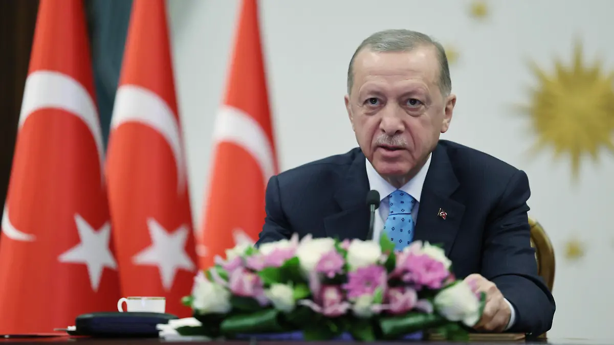 In this handout photo released by Turkish Presidency, Turkey's President Recep Tayyip Erdogan inaugurates Turkey's first nuclear power plant via a video link, at the Presidential palace in Ankara, Thursday, April 27, 2023. Sitting behind a desk surrounded by Cabinet members, aides and political allies, the 69-year-old leader remotely presided over the event marking the delivery of the first fuel to Russian-built Akkuyu Nuclear Power Plant, in southern Turkey. (Turkish Presidency via AP)