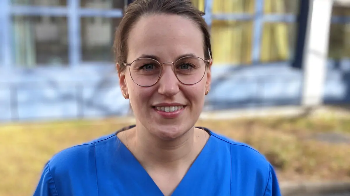 Man sieht Meike Ista in ihrer Arbeitsuniform der Krankenpflegerin.