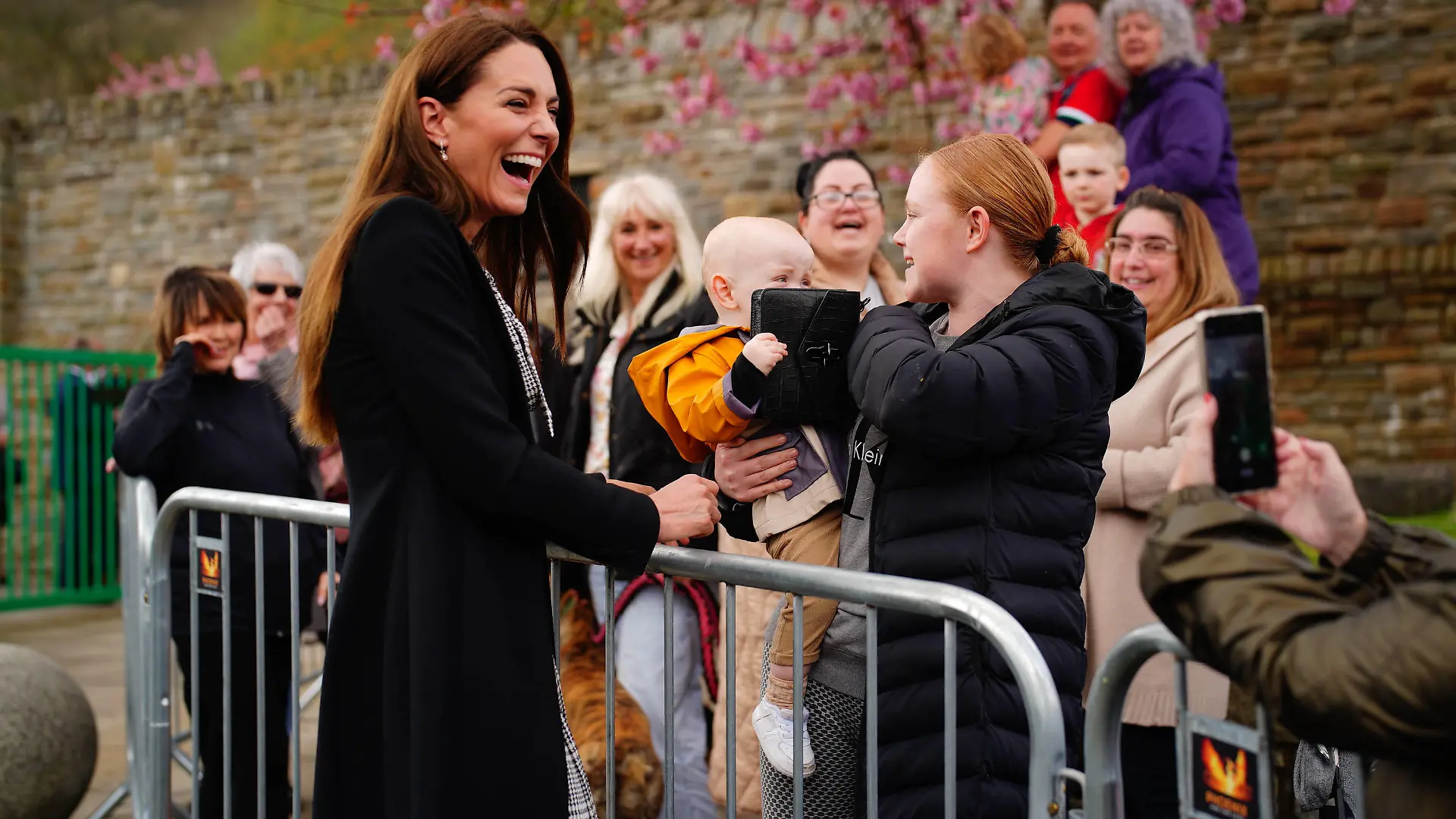 Entertainment Bilder des Tages . 28/04/2023. Aberfan, United Kingdom. A child plays with the handbag of Kate Middleton, the Princess of Wales , during a visit to the Aberfan memorial garden in Wales,United Kingdom, to pay her respects to those who lost their lives during the Aberfan disaster in 1966. PUBLICATIONxINxGERxSUIxAUTxHUNxONLY xPoolx/xi-Imagesx IIM-24325-0016