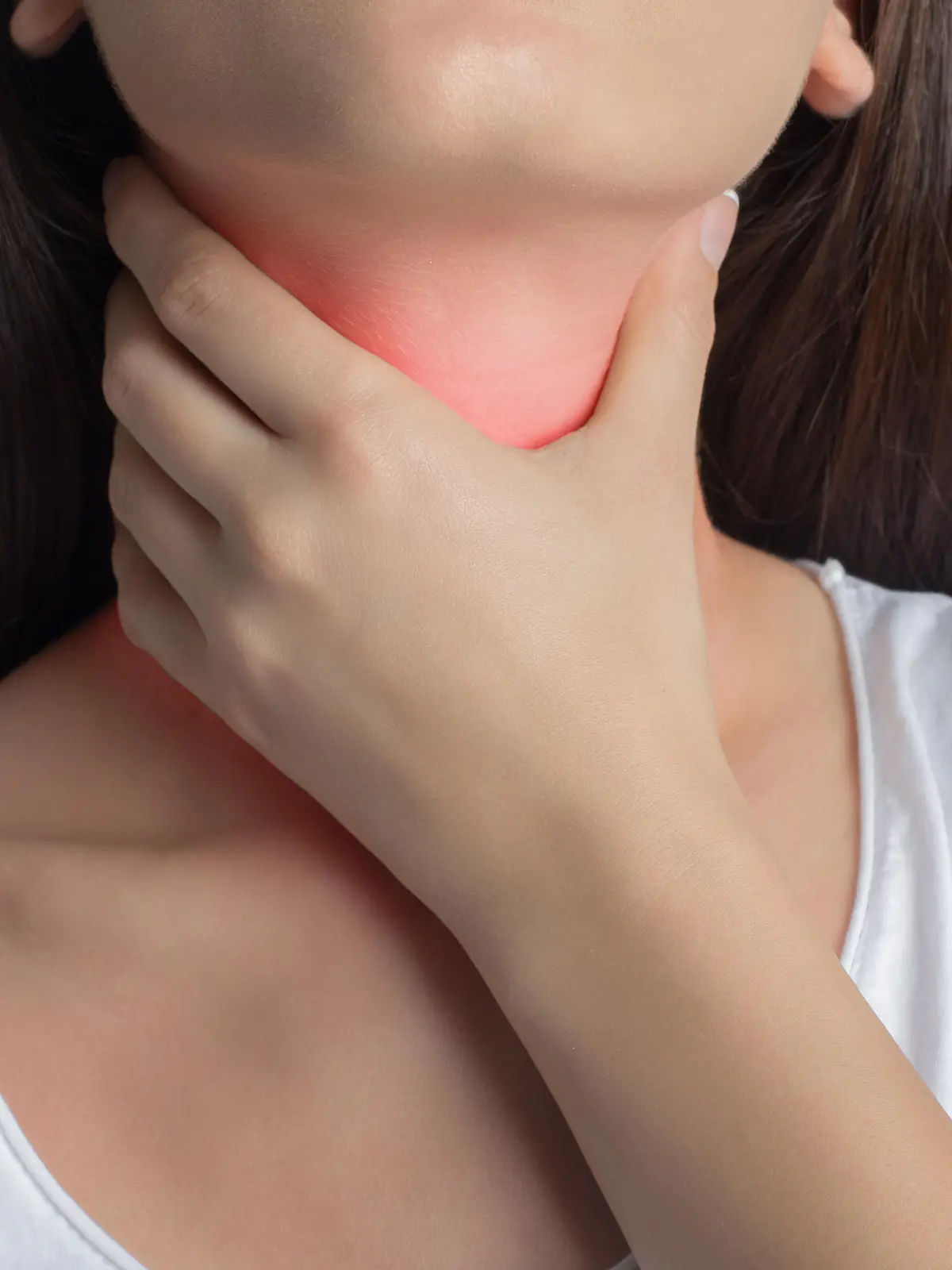 Woman holds her throat