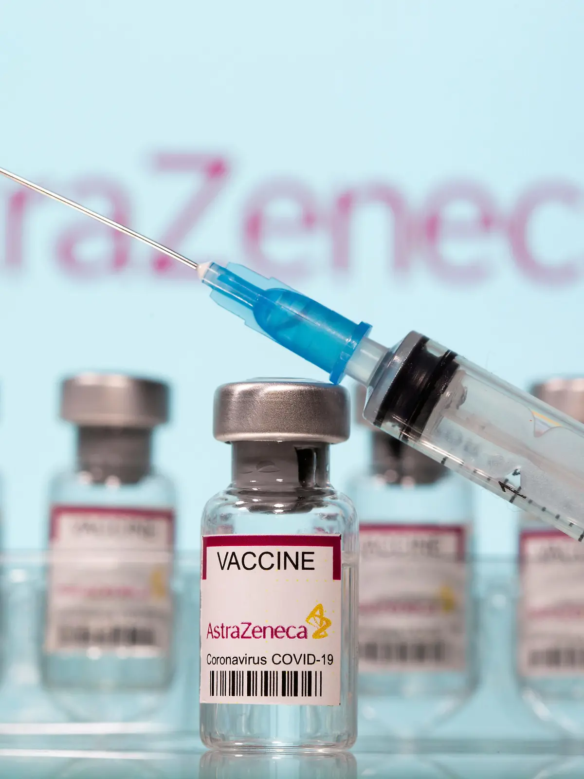 FILE PHOTO: Vials labelled "AstraZeneca COVID-19 Coronavirus Vaccine" and a syringe in front of an AstraZeneca logo in this illustration taken March 10, 2021. REUTERS/Dado Ruvic/Illustration/File Photo
