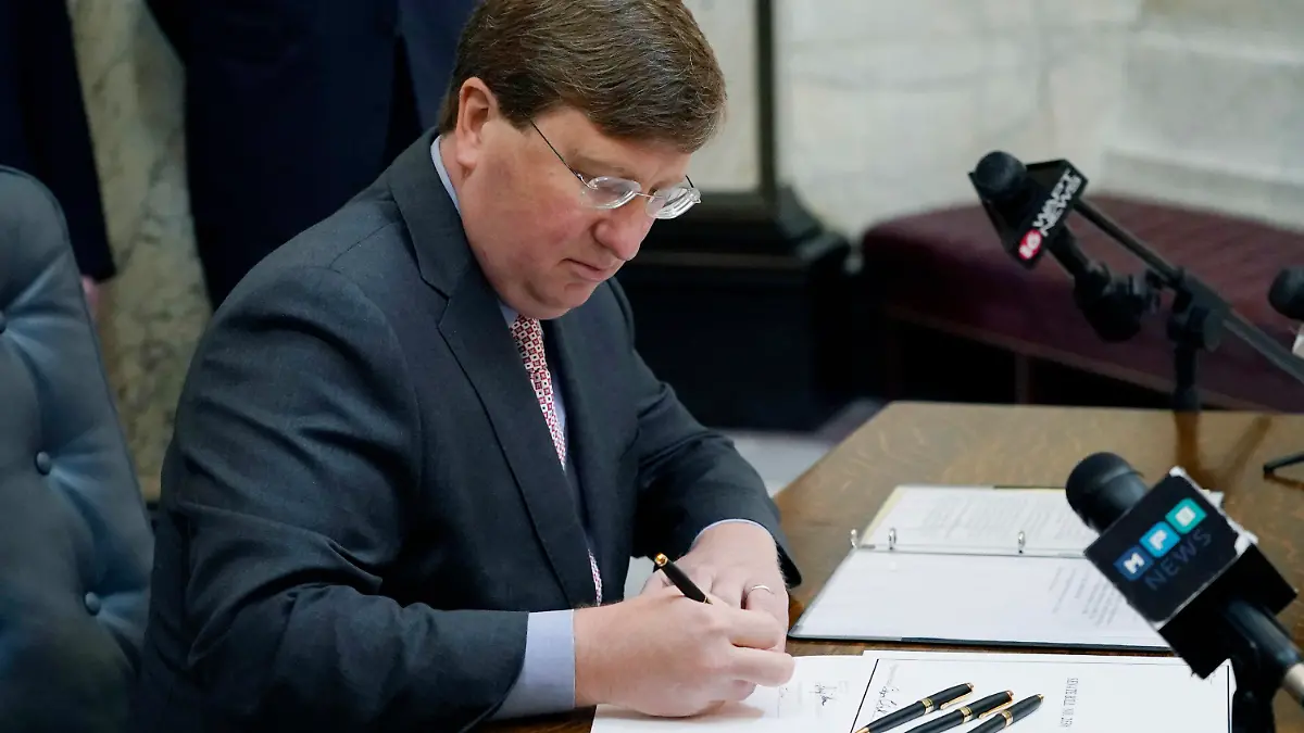 Mississippi Gov. Tate Reeves signs the first state bill in the U.S. this year to ban transgender athletes from competing on female sports teams Thursday, March 11, 2021, at the Capitol in Jackson, Miss. (AP Photo/Rogelio V. Solis)