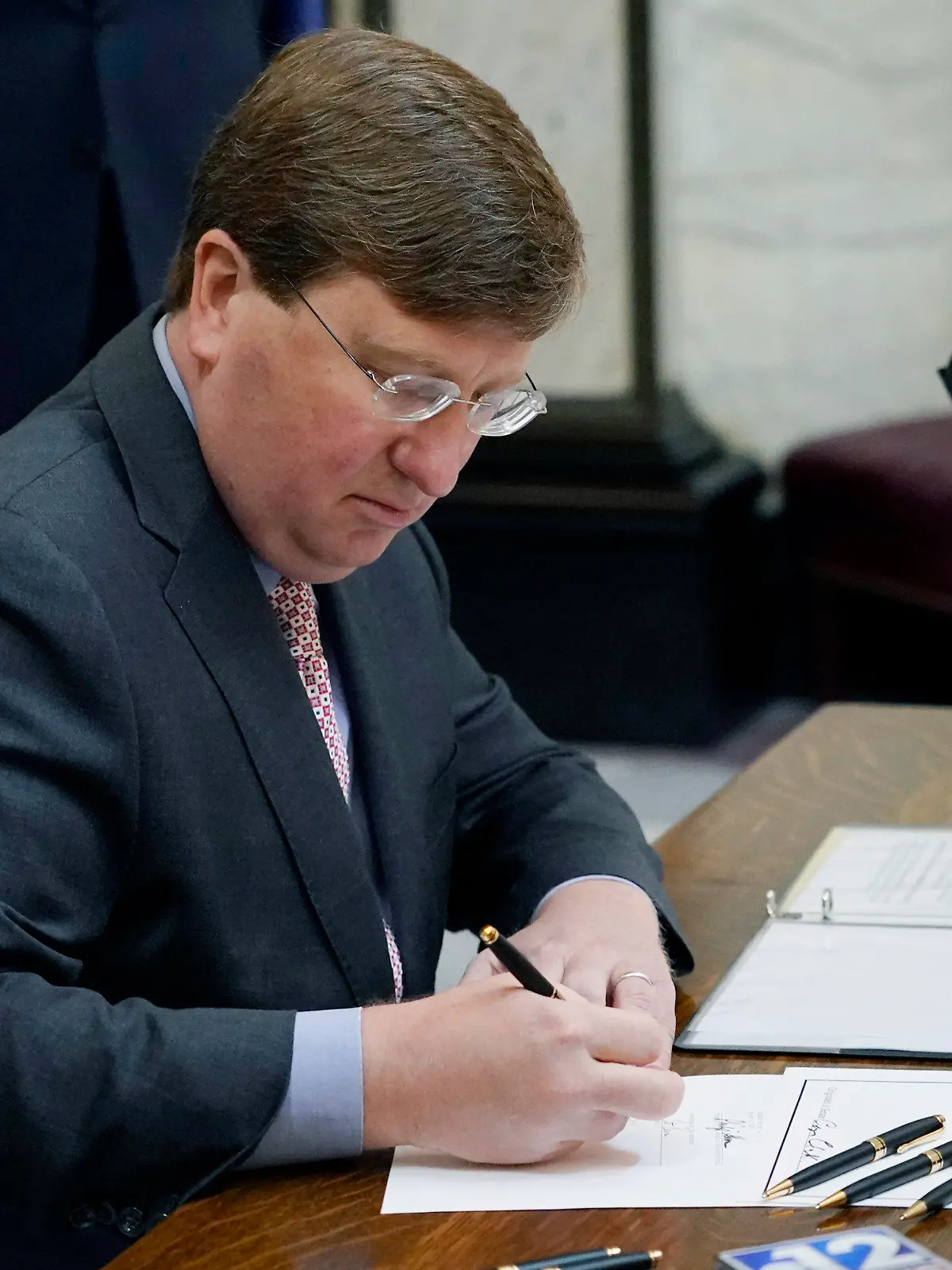 Mississippi Gov. Tate Reeves signs the first state bill in the U.S. this year to ban transgender athletes from competing on female sports teams Thursday, March 11, 2021, at the Capitol in Jackson, Miss. (AP Photo/Rogelio V. Solis)