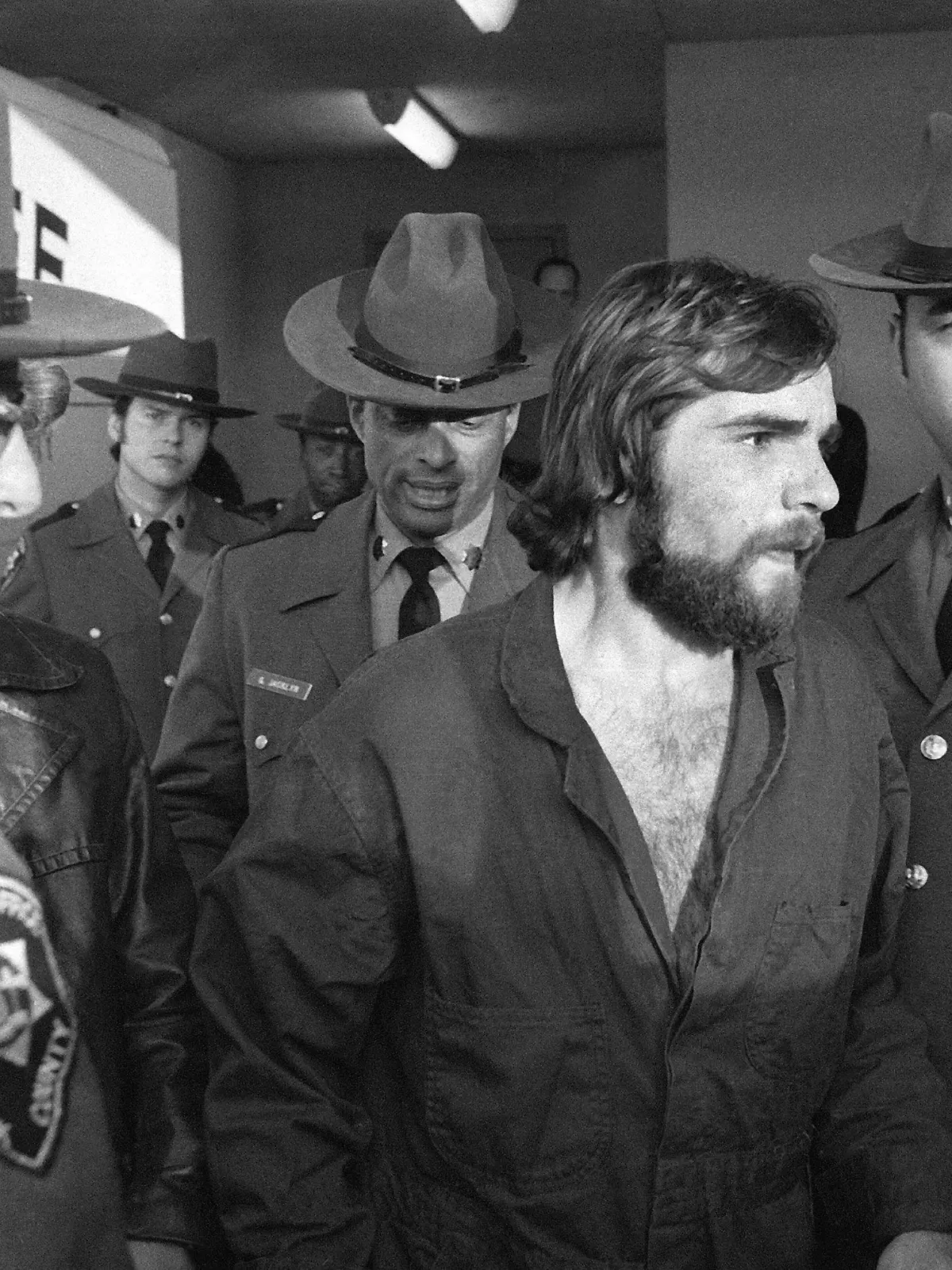 FILE - In this Nov. 15, 1974 file photo, Ronald DeFeo Jr., center, leaves Suffolk County district court after a hearing, on New York's Long Island. DeFeo, the man convicted of slaughtering his parents and four siblings in a home that later inspired the book and movie "The Amityville Horror"  died Friday, March 12, 2021, at Albany Medical Center,  where he was taken Feb. 2 from a prison in New York’s Catskill Mountains, prison officials said Monday, March 15. He was 69. (AP Photo/Richard Drew, File)