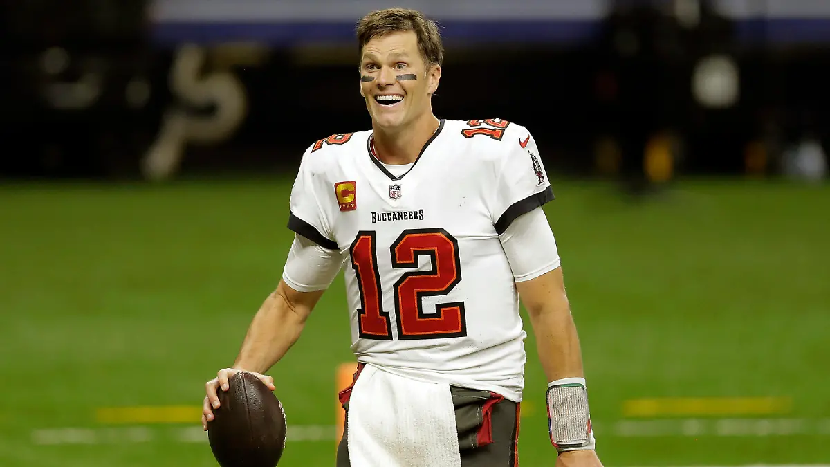 FILE - Tampa Bay Buccaneers quarterback Tom Brady leaves the field an NFL divisional round playoff football game against the New Orleans Saints in New Orleans, in this Sunday, Jan. 17, 2021, file photo. om Brady has agreed to a contract extension with the Buccaneers that provides the Super Bowl champions with much-needed salary cap relief and will help the seven-time NFL champion reach a goal of playing until he’s at least 45. Brady posted a picture of himself on Twitter, signing the extension Friday, March 12, 2021, with the message: “In pursuit of 8 ... LFG@ Buccaneers we’re keeping the band together.” (AP Photo/Brett Duke, File)