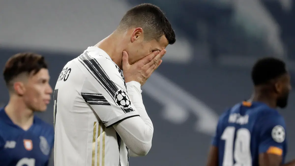 FILE - In this Tuesday, March 9, 2021 file photo Juventus' Cristiano Ronaldo reacts during the Champions League, round of 16, second leg, soccer match between Juventus and Porto in Turin, Italy. Neither Lionel Messi nor Cristiano Ronaldo will be in the Champions League quarterfinals for the first time since 2005. The two greatest players of the current generation were both eliminated from the competition this week. Messi scored a goal but missed a penalty as Barcelona was eliminated by Paris Saint-Germain. Ronaldo and his Juventus teammates were ousted by Porto the night before. Ronaldo has won five Champions League titles in his career. Messi has won four.  (AP Photo/Luca Bruno, File)