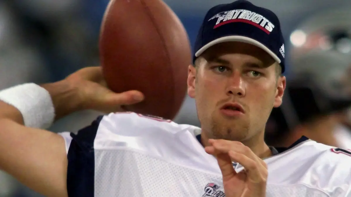 FILE - In this Aug. 4, 2000, file photo, New England Patriots backup quarterback Tom Brady warms up on the sidelines before an NFL football game against the Detroit Lions at the Silverdome in Pontiac, Mich. Brady grew from a sixth-round draft choice into one of the best quarterbacks in NFL history. On Tuesday, NFL commissioner Roger Goodell hears Brady's appeal of a four-game suspension for using deflated footballs in the AFC championship game. How will that affect Brady's legacy? (AP Photo/Carlos Osorio, File)